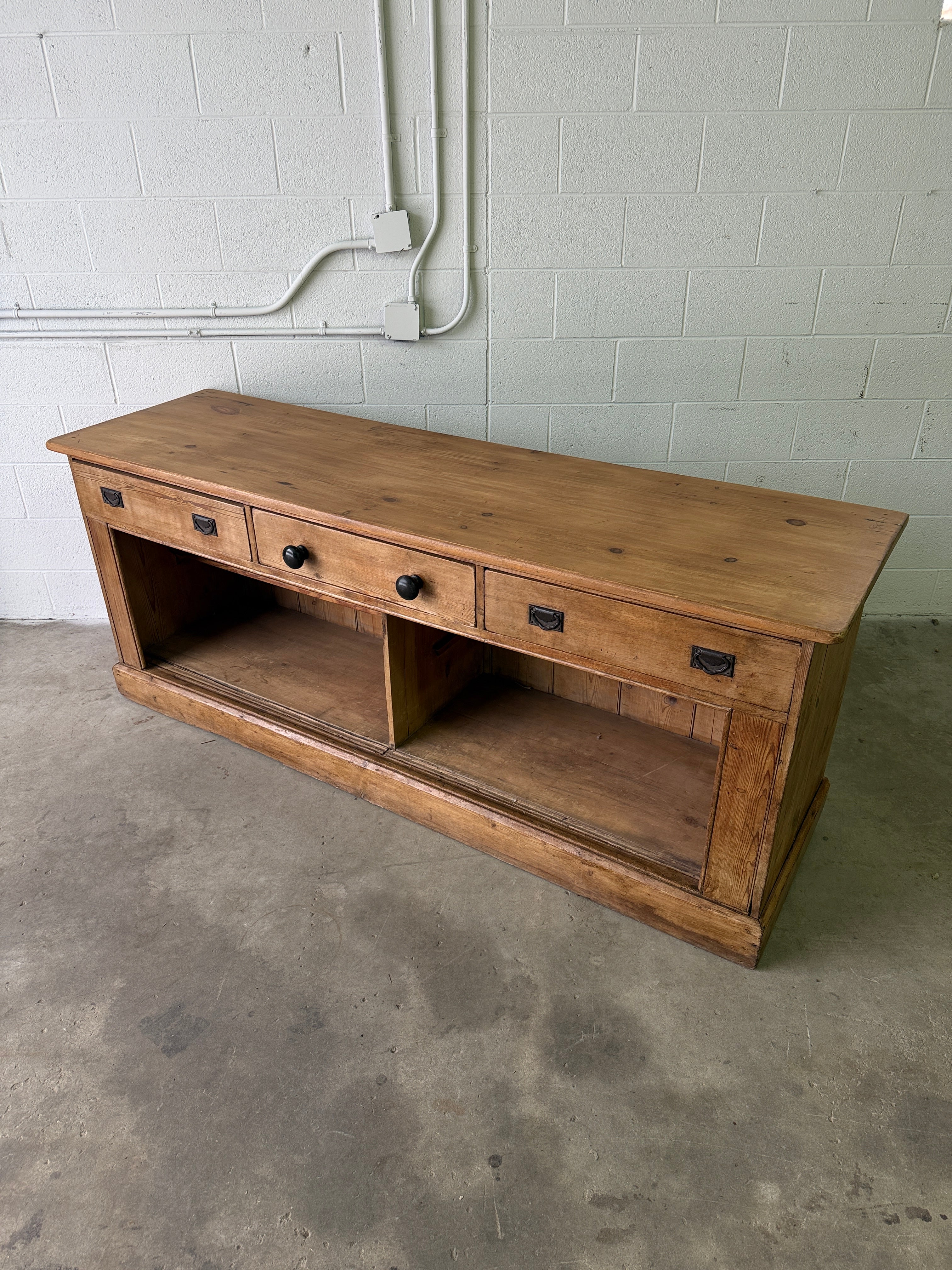 Antique English pine sideboard with open storage