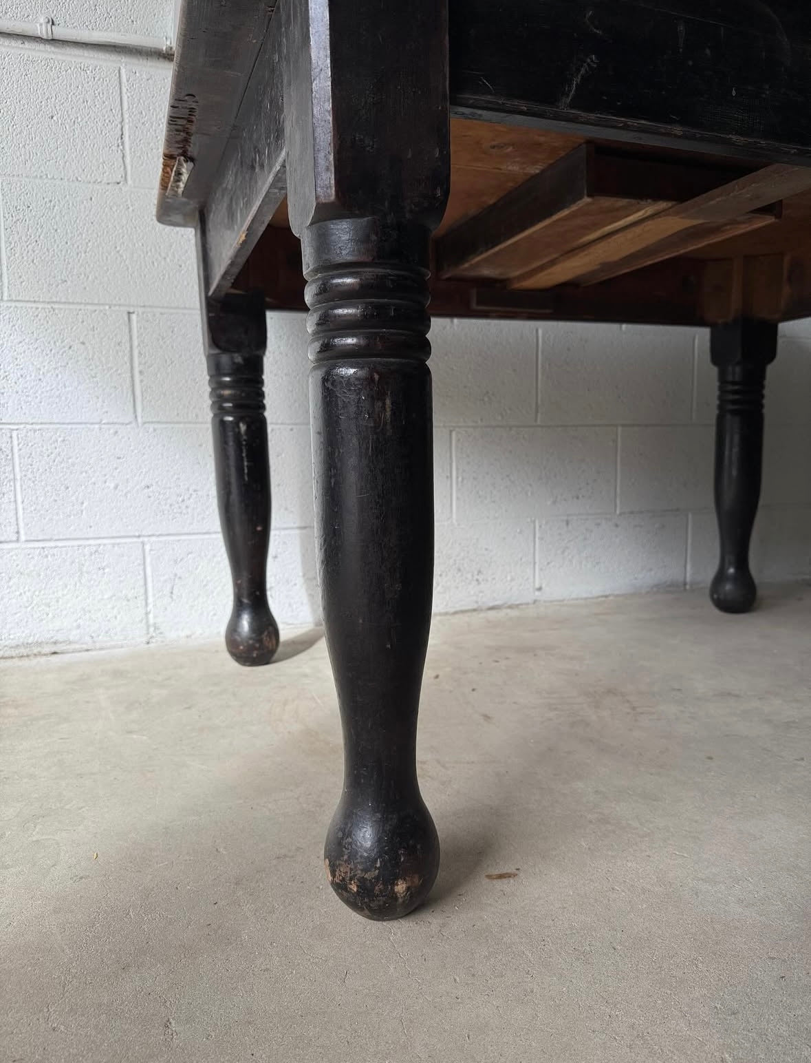 Antique black pine table with turned legs