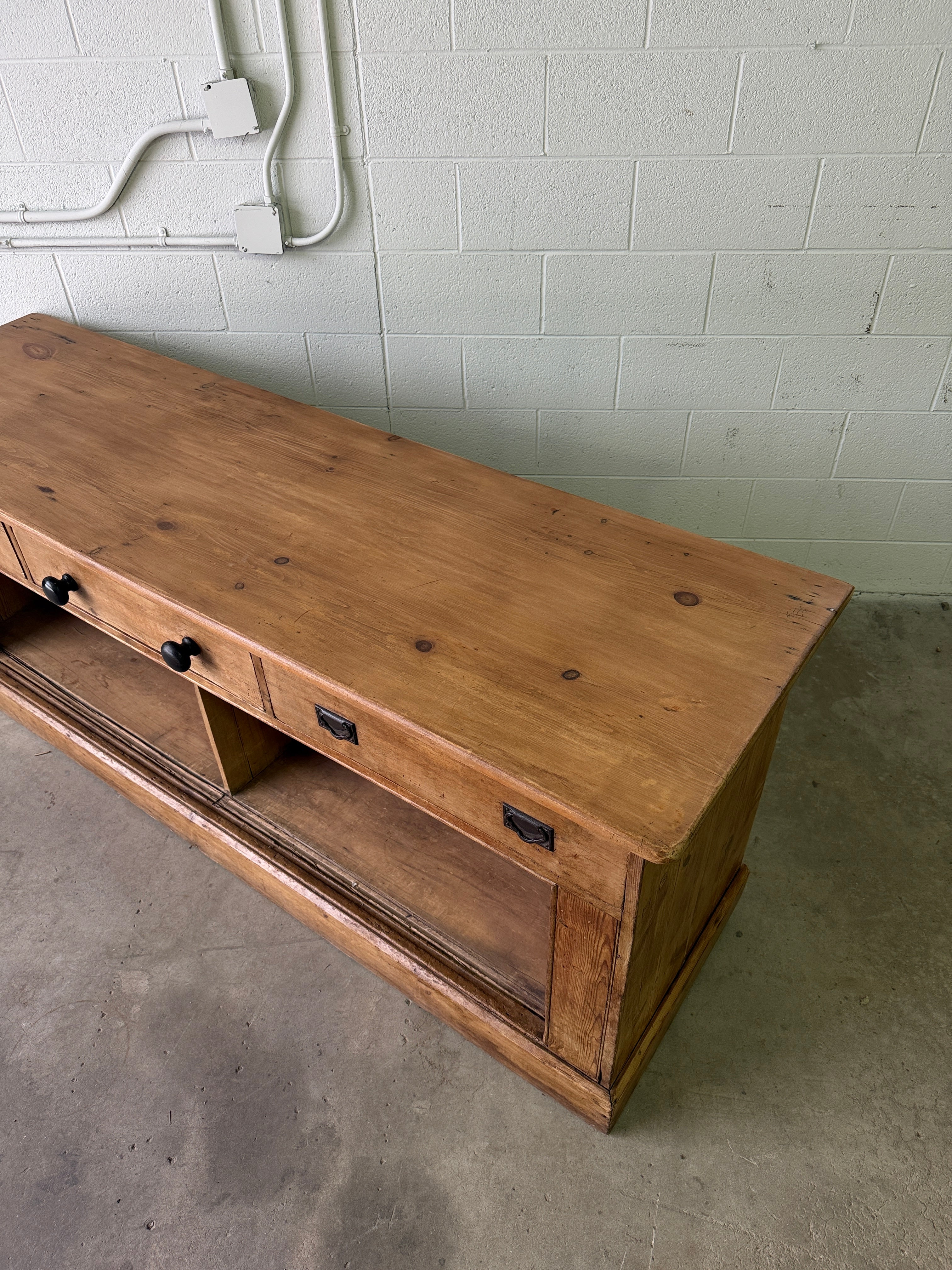 Antique English pine sideboard with open storage