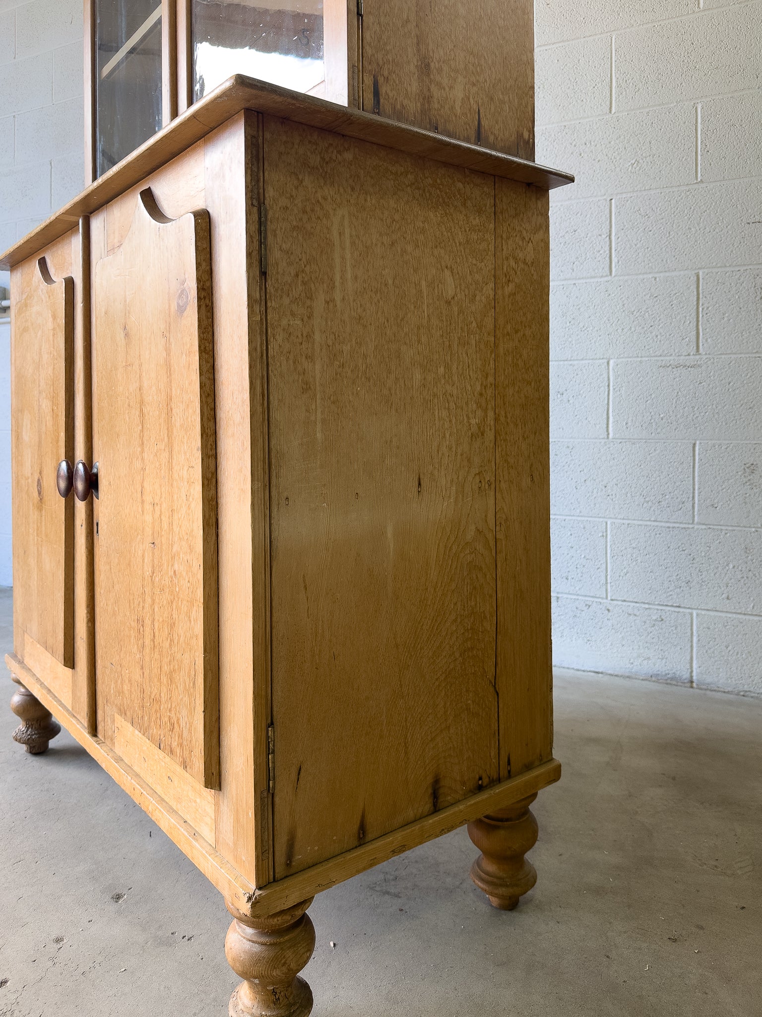 Antique English pine cupboard with wavy glass