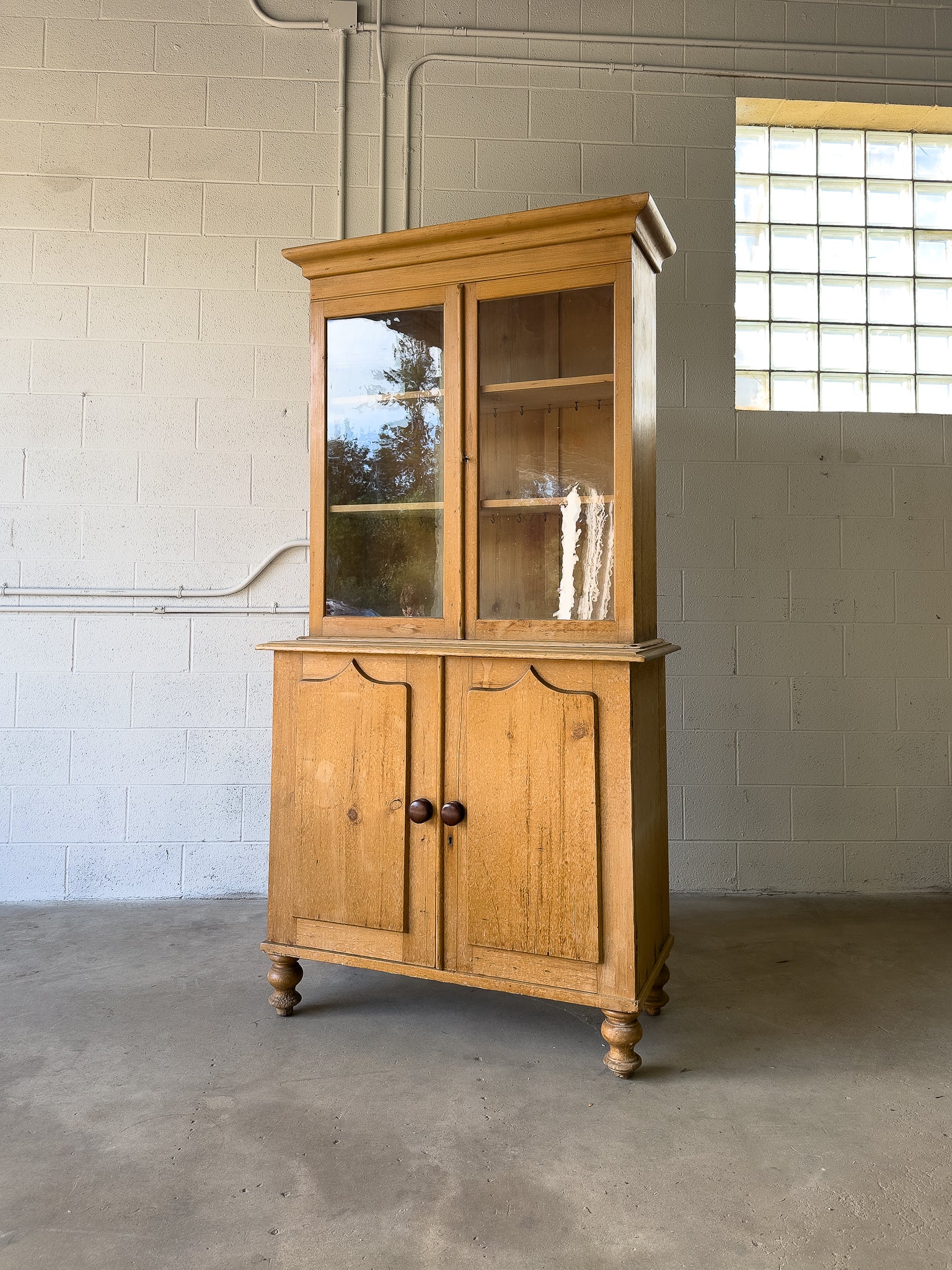 Antique English pine cupboard with wavy glass
