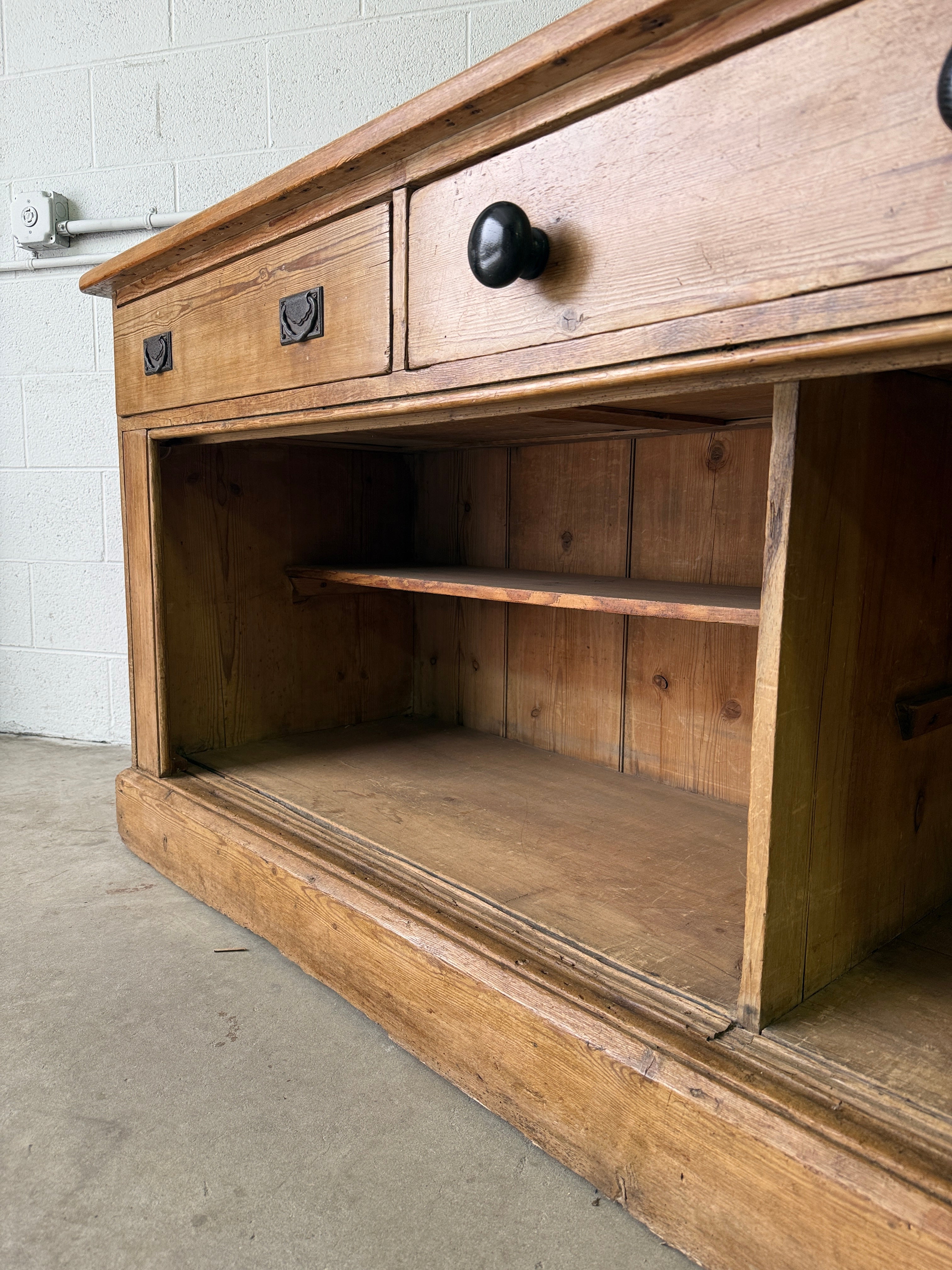 Antique English pine sideboard with open storage