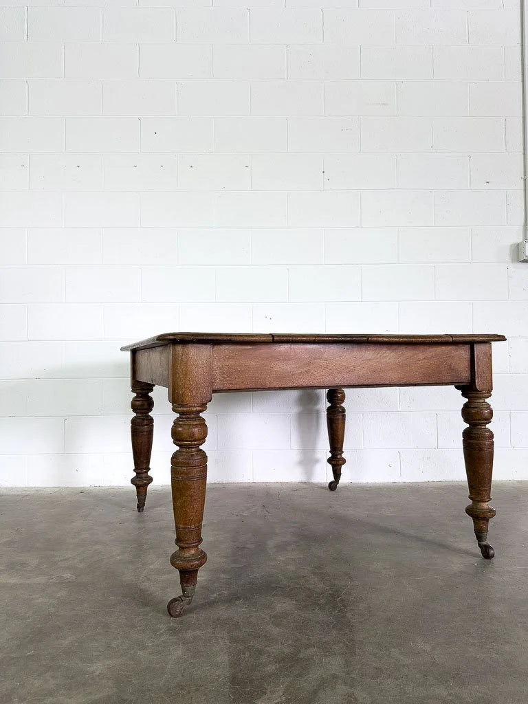 Square English breakfast table with turned legs and castors