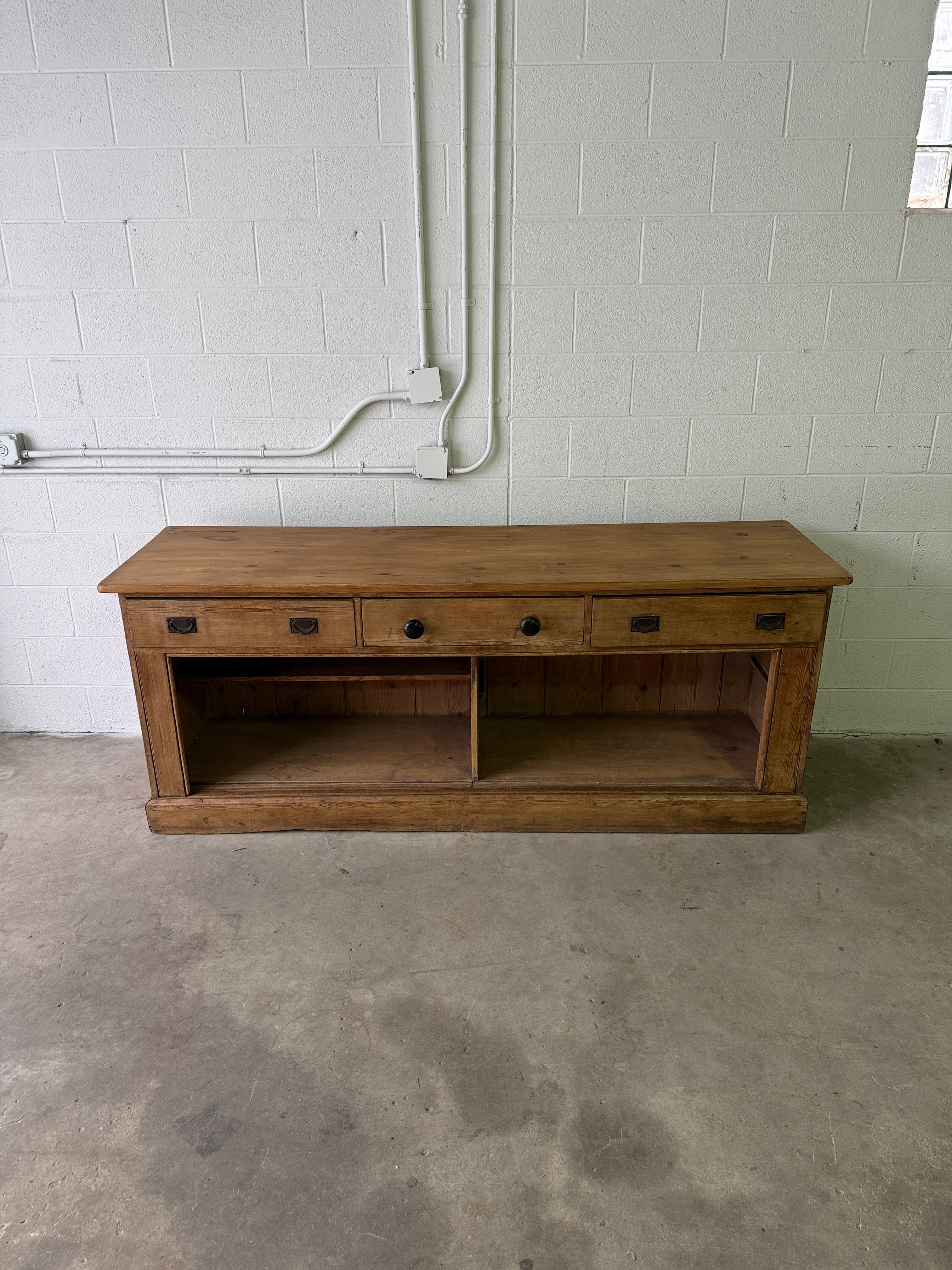 Antique English pine sideboard with open storage