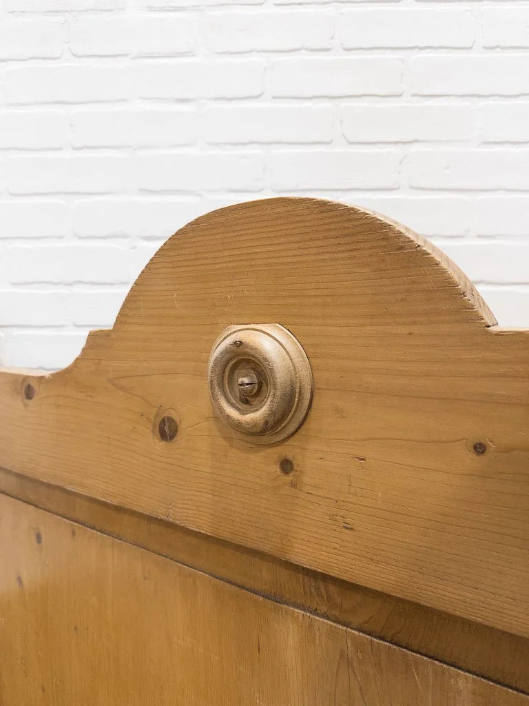 Antique English pine sleigh bed with turned rosette