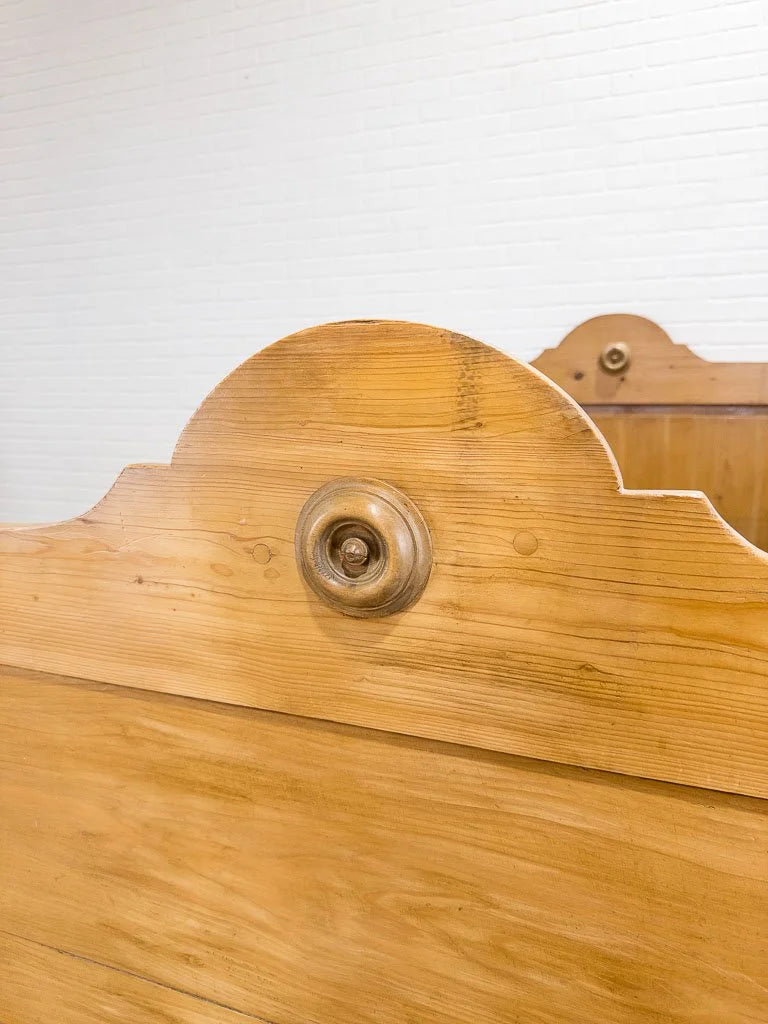 Antique English pine sleigh bed with turned rosette