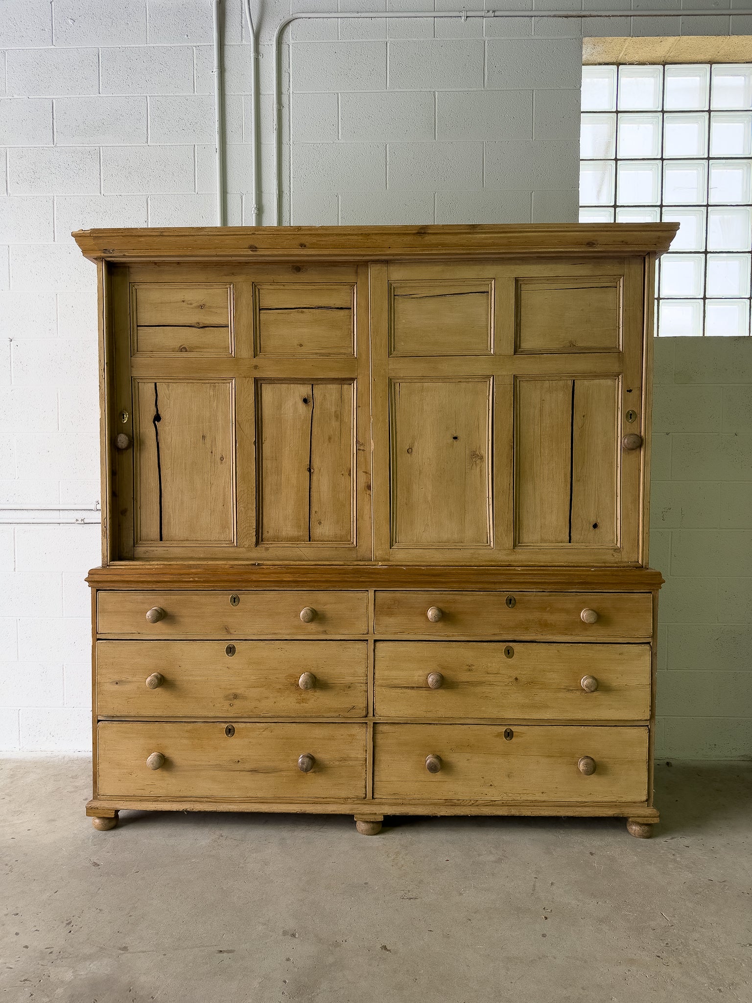 Large antique pine housekeepers cupboard with sliding doors