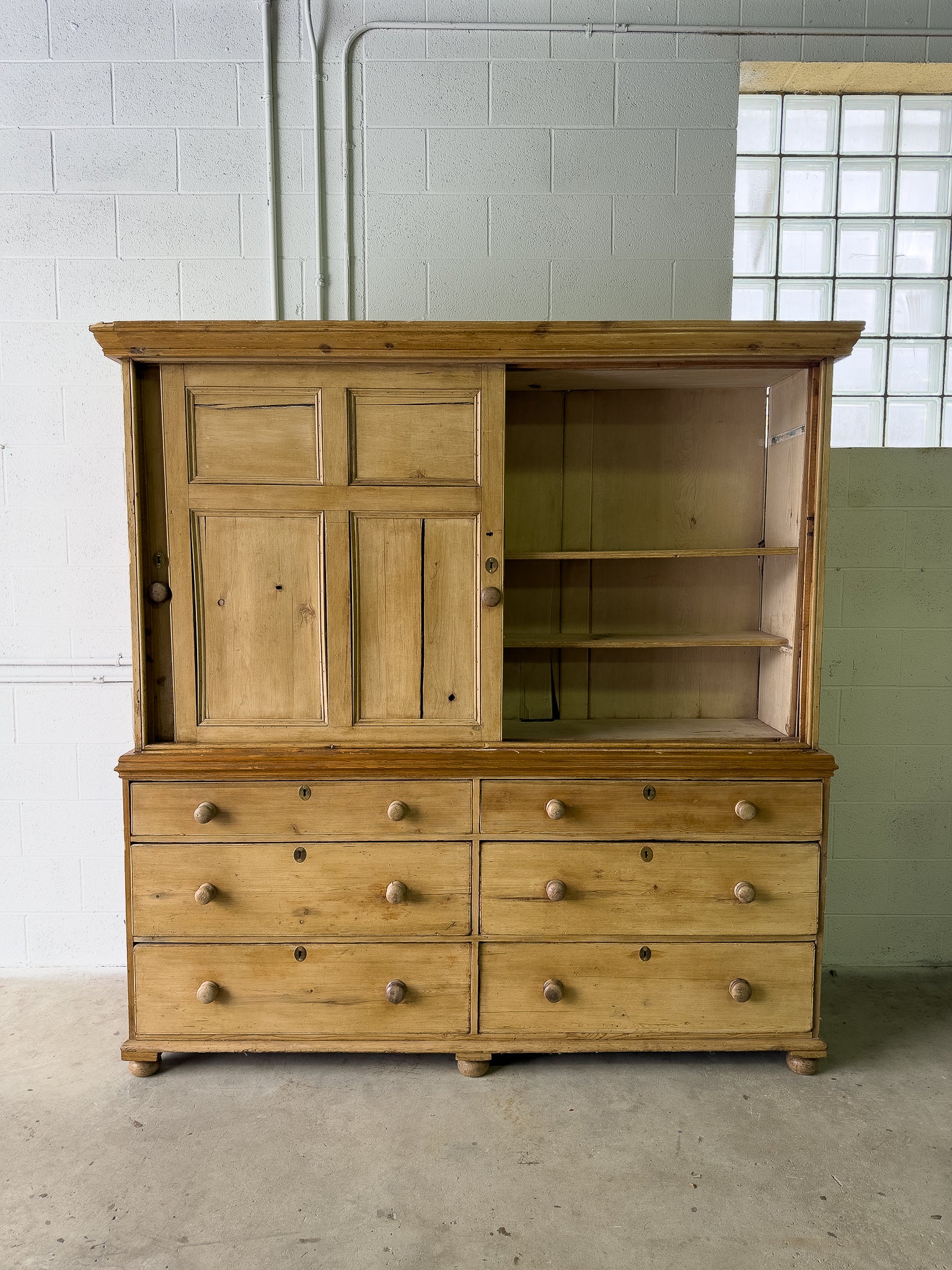 Large antique pine housekeepers cupboard with sliding doors