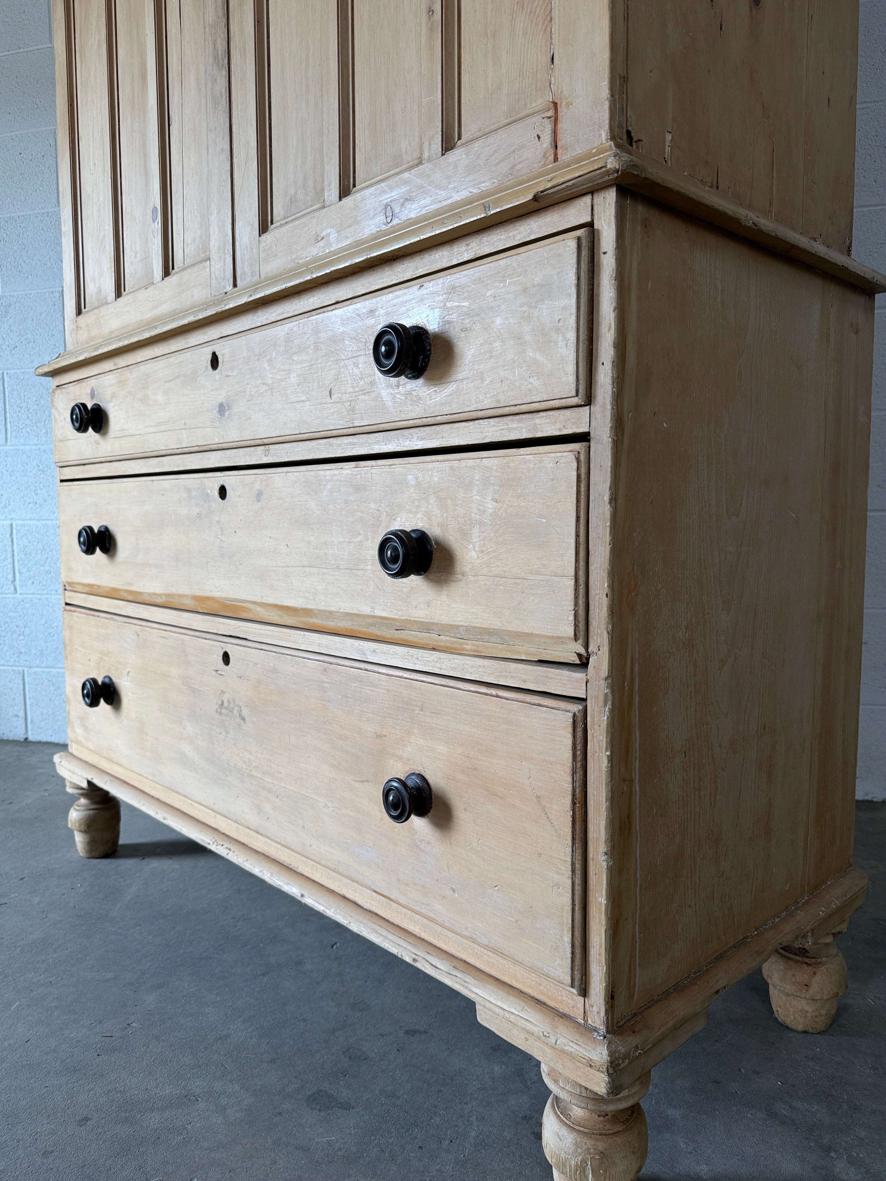 Antique English pine linen press with paneled doors