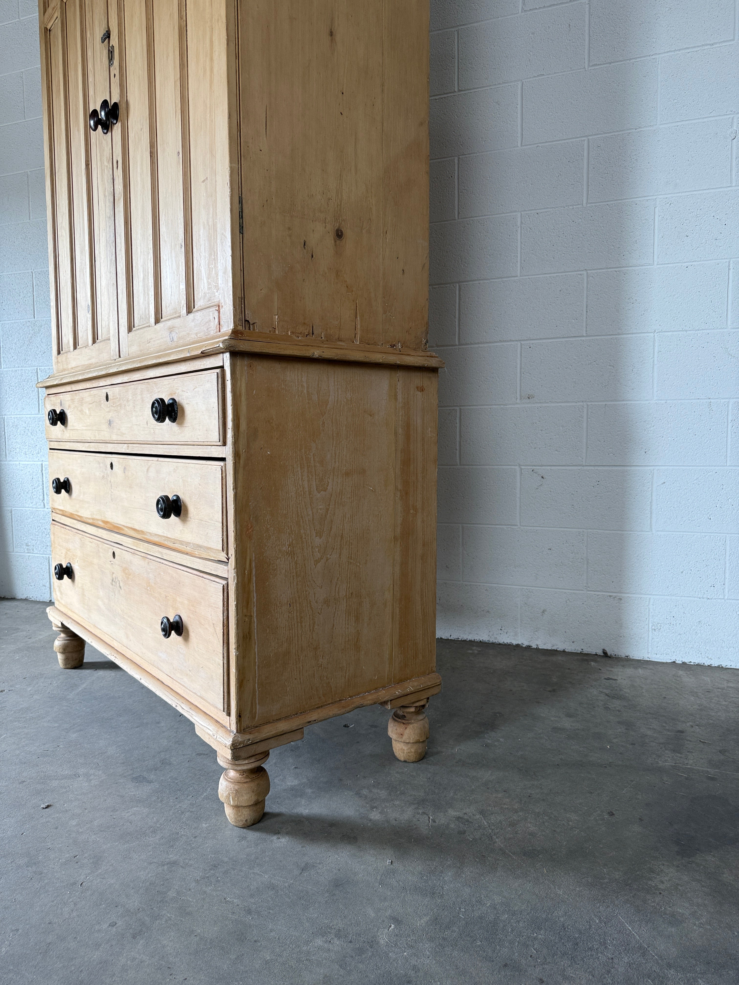 Antique English pine linen press with paneled doors