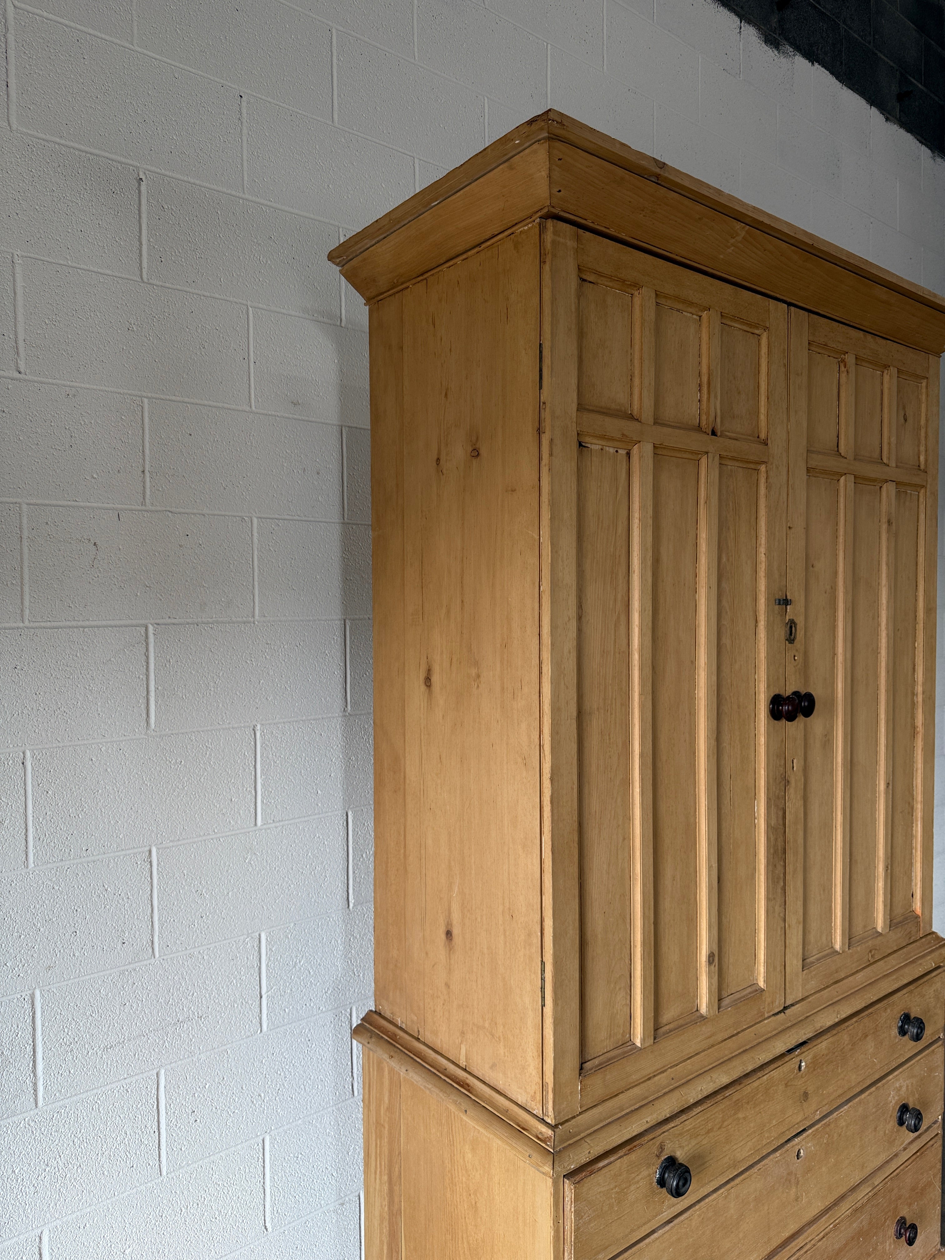 Antique English pine linen press with paneled doors