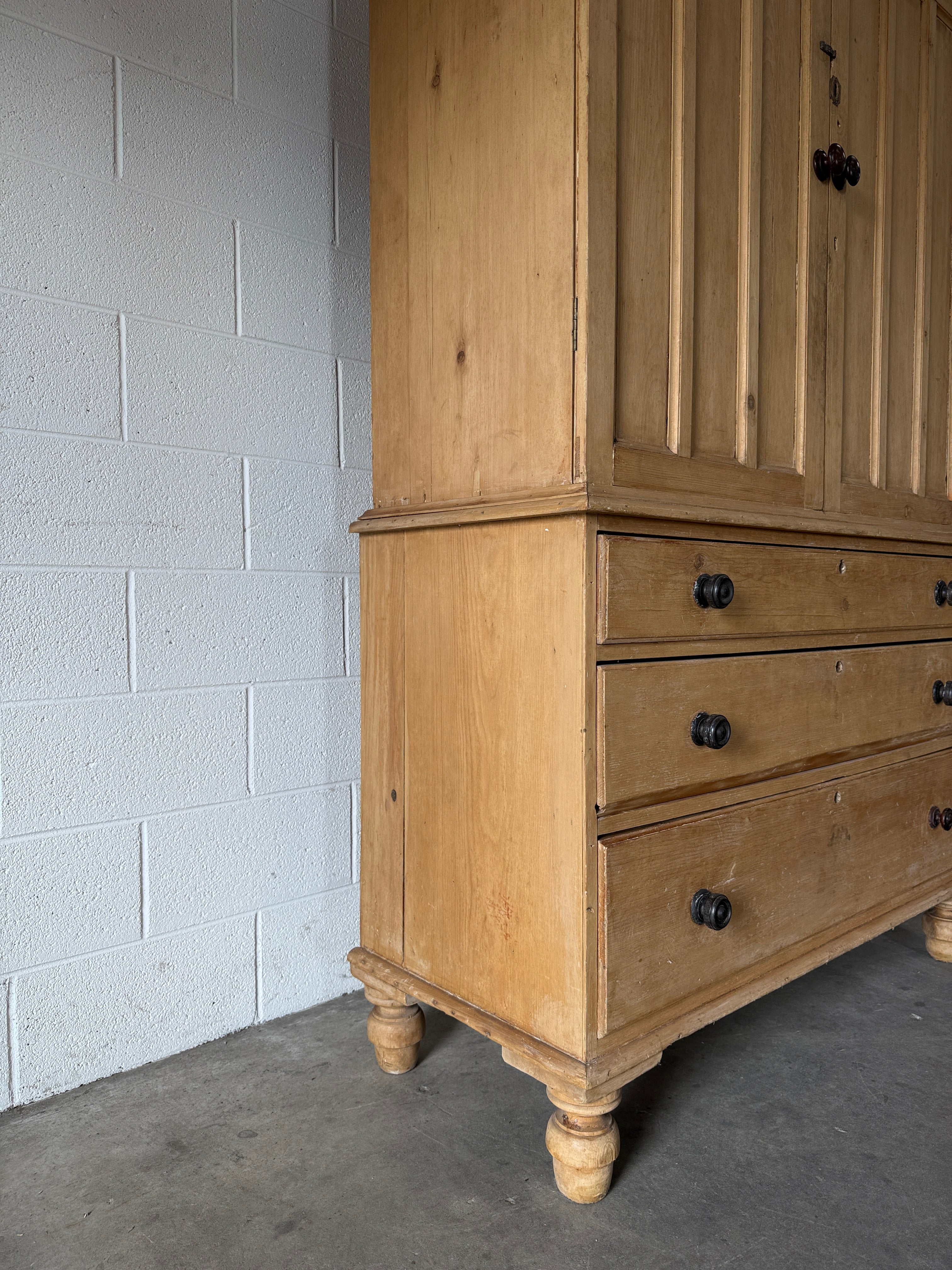 Antique English pine linen press with paneled doors