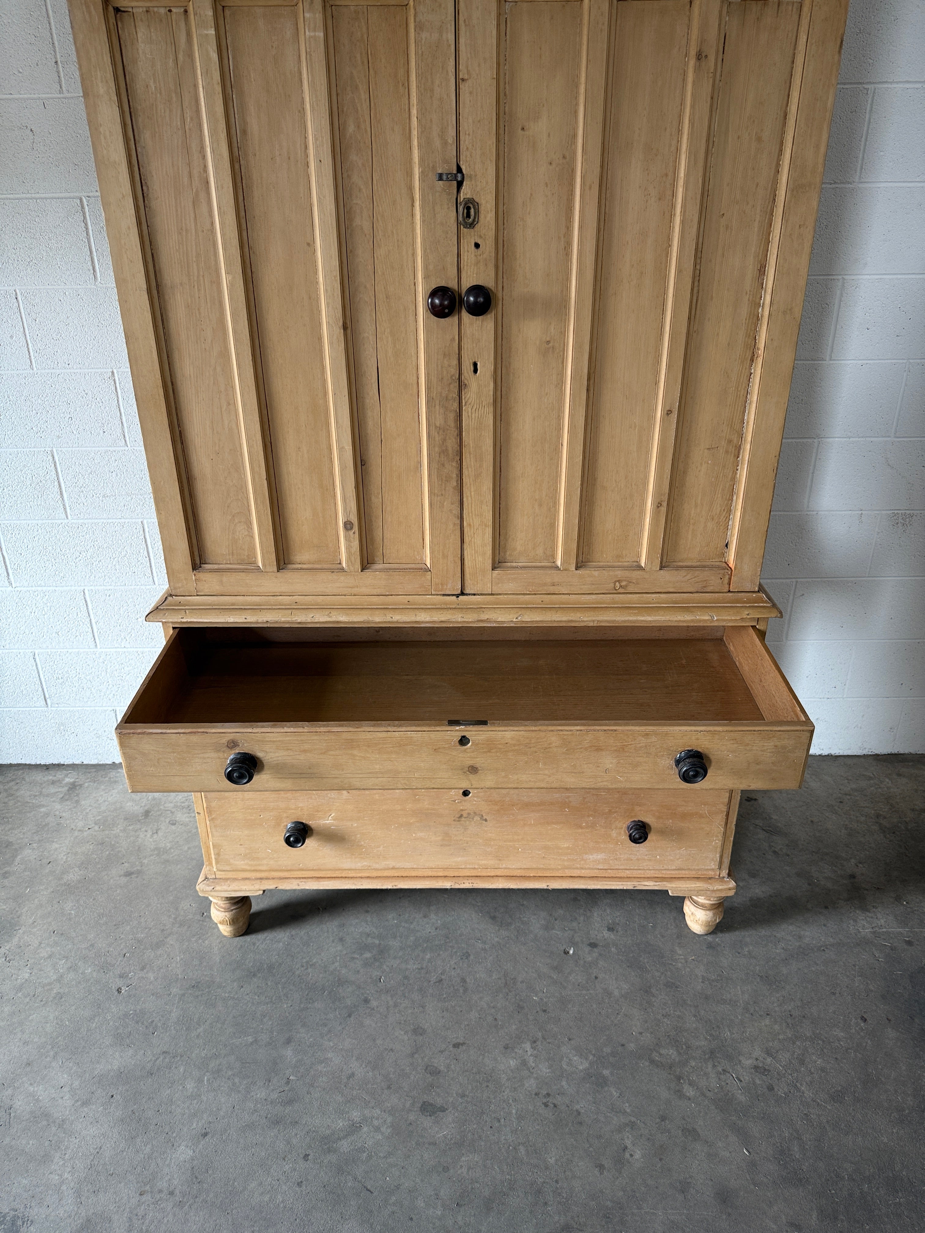 Antique English pine linen press with paneled doors