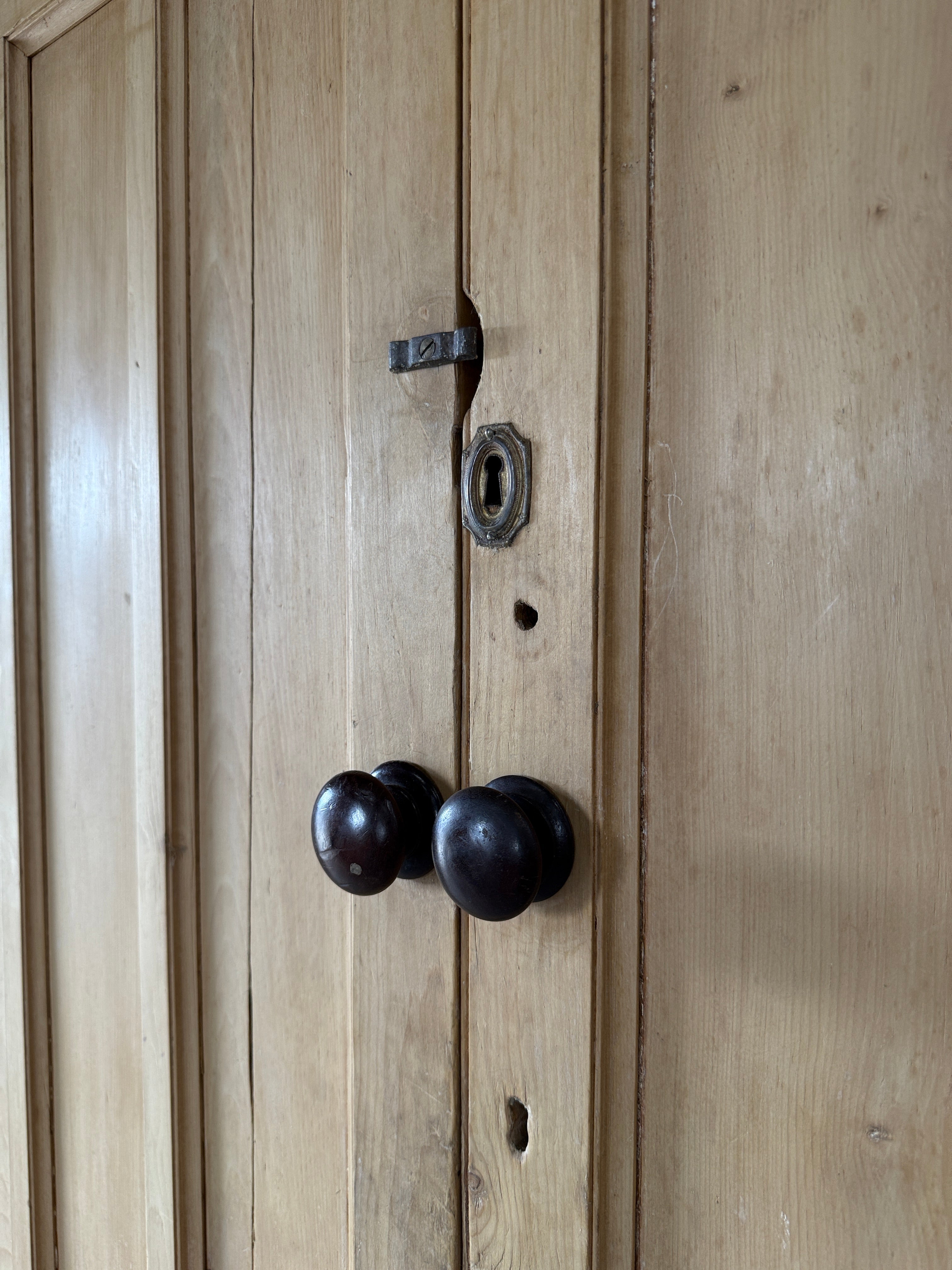 Antique English pine linen press with paneled doors
