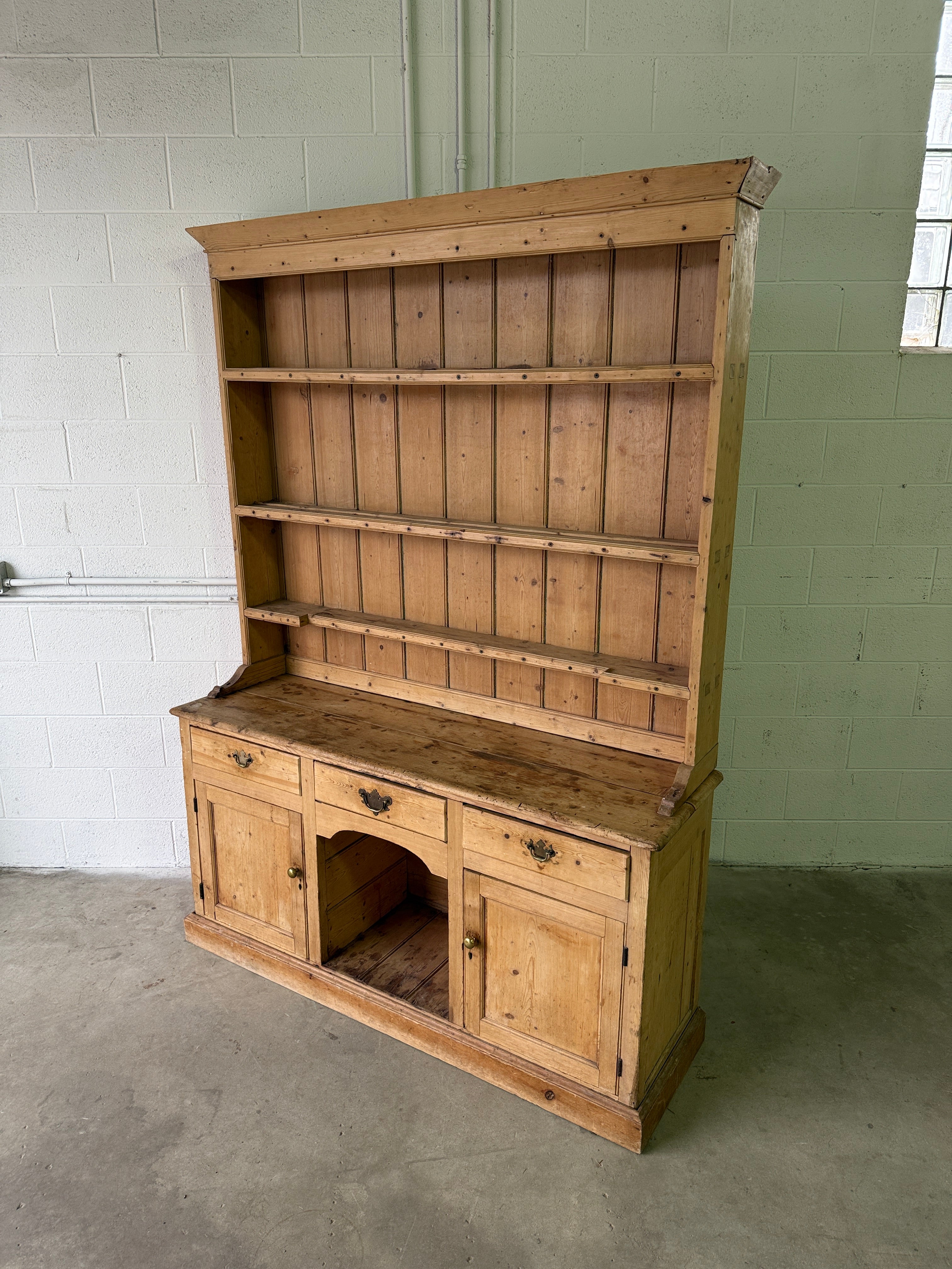 Striking antique pine kitchen dresser with brass pulls