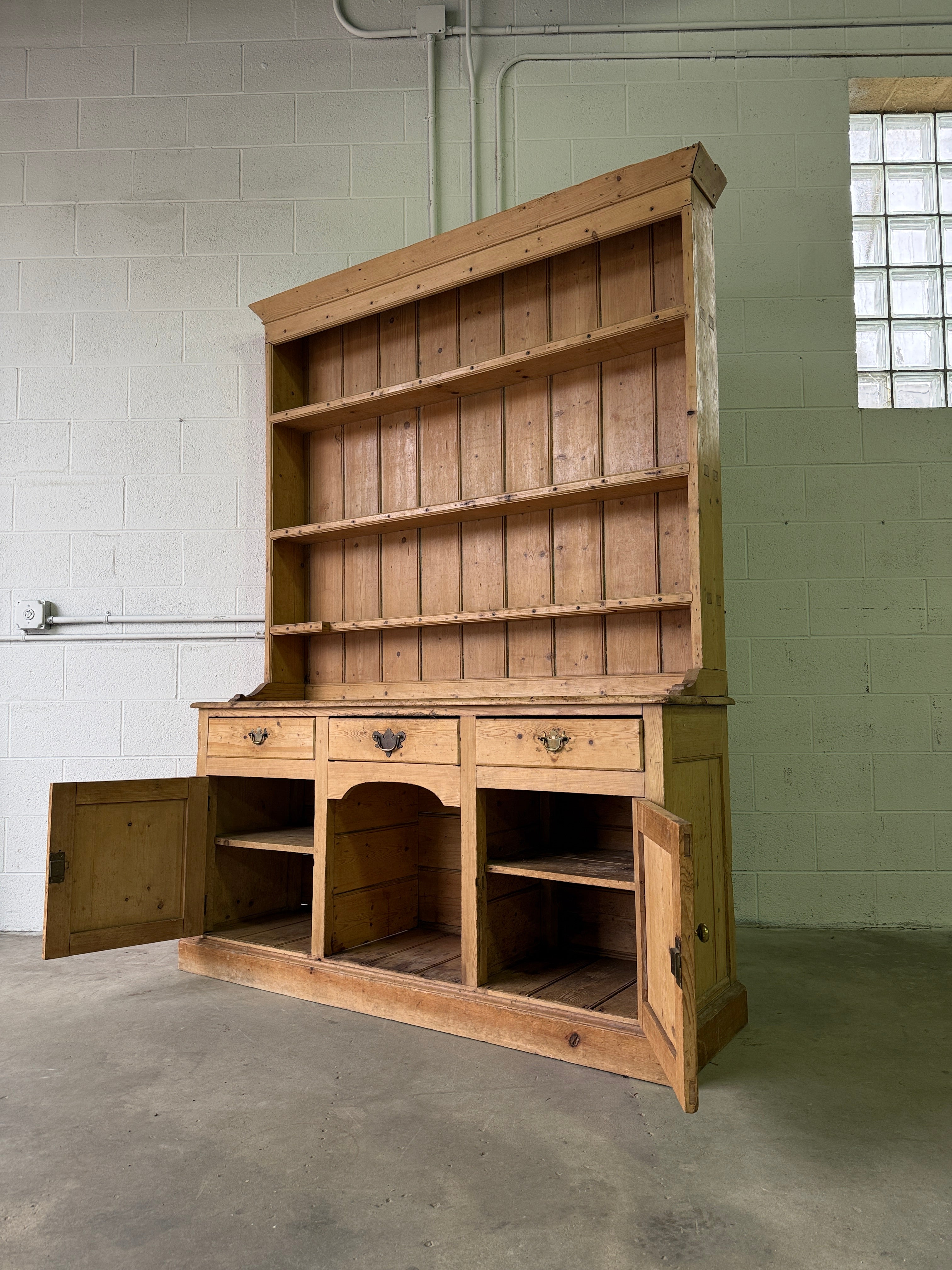 Striking antique pine kitchen dresser with brass pulls