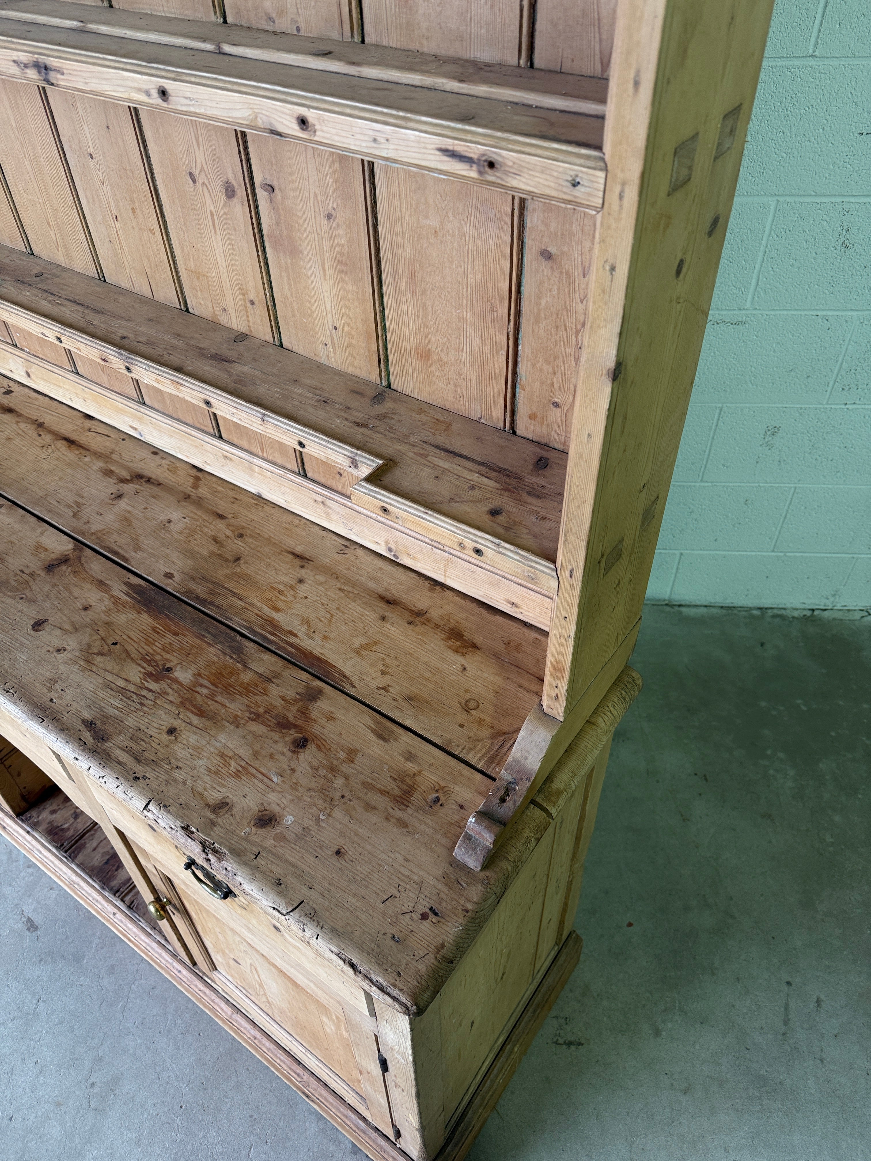 Striking antique pine kitchen dresser with brass pulls