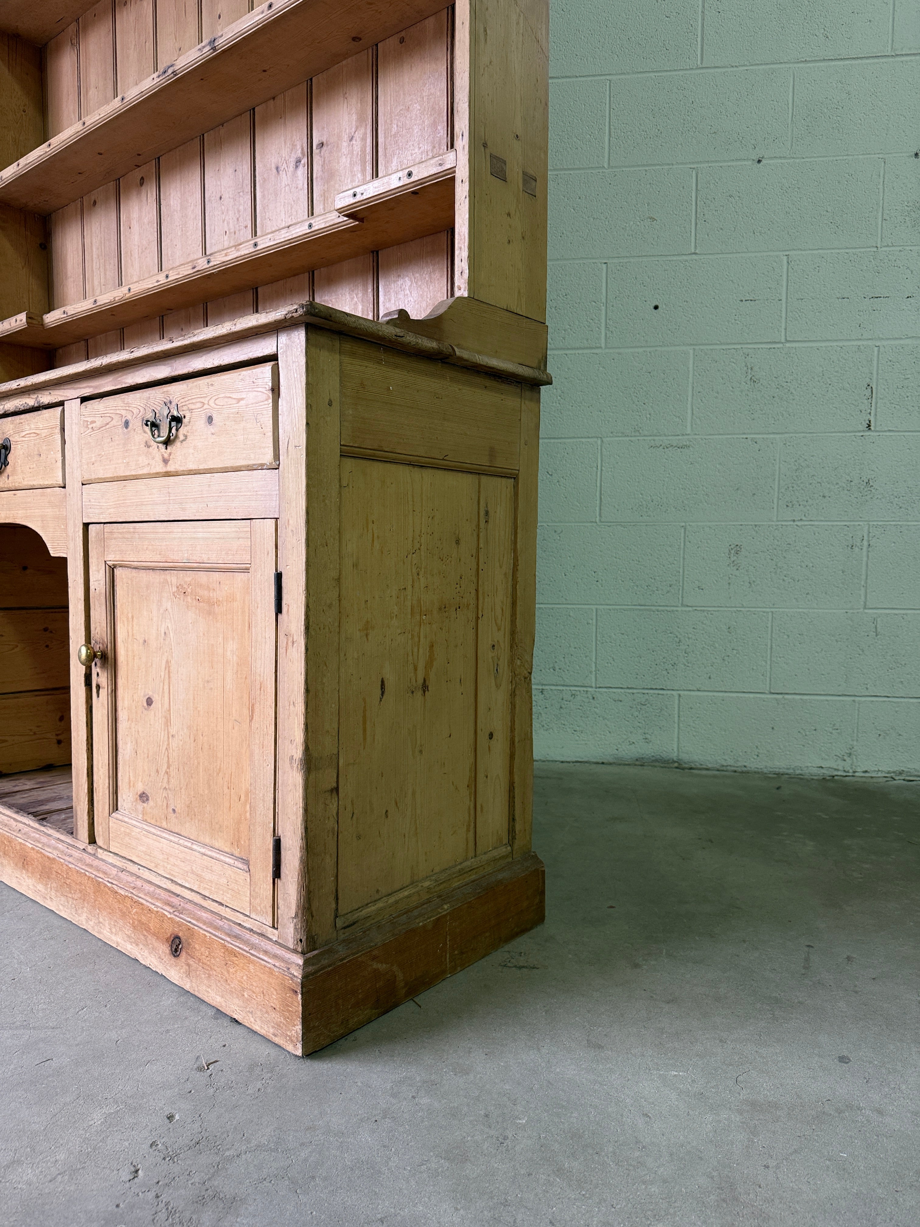 Striking antique pine kitchen dresser with brass pulls