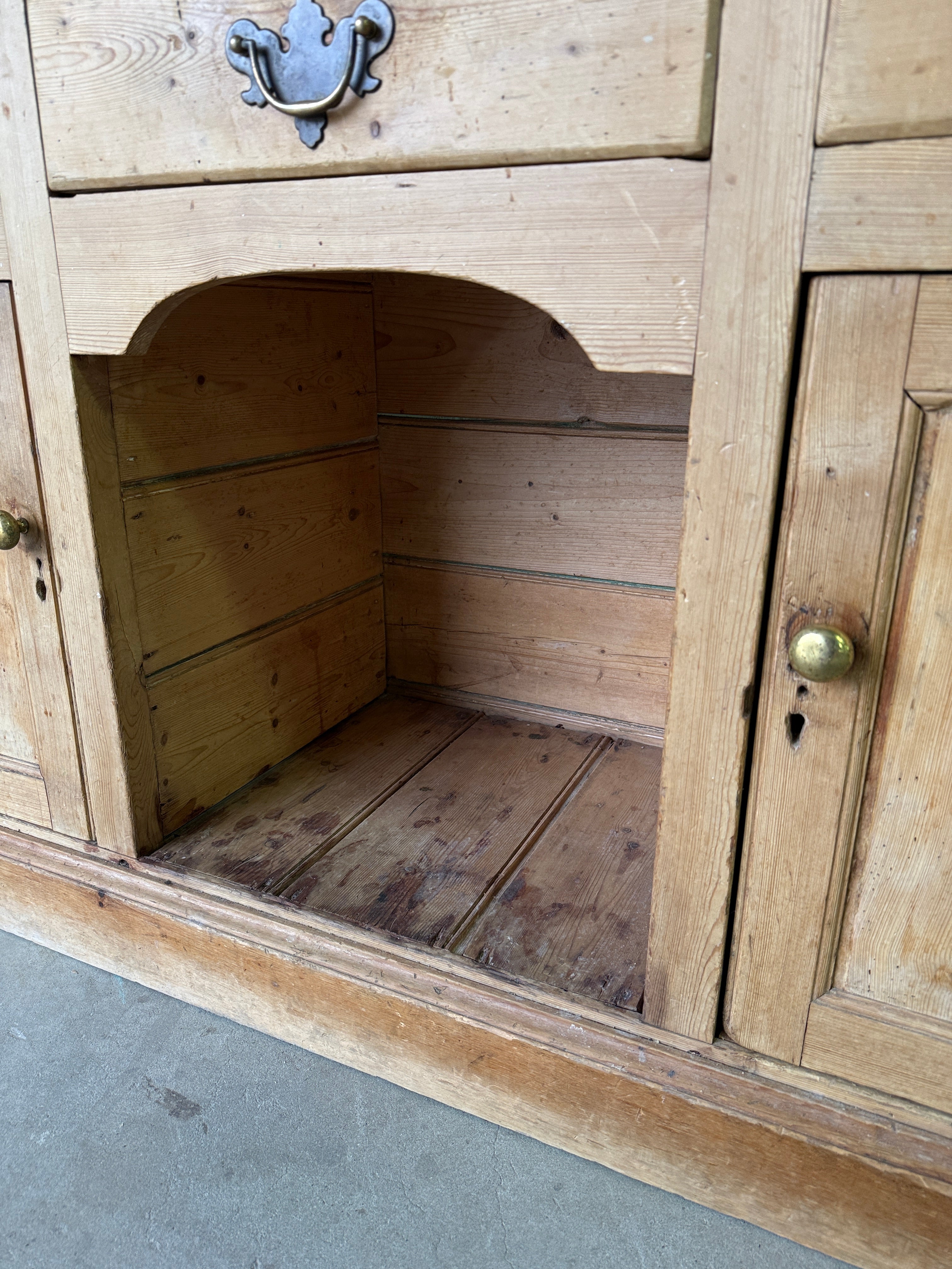 Striking antique pine kitchen dresser with brass pulls