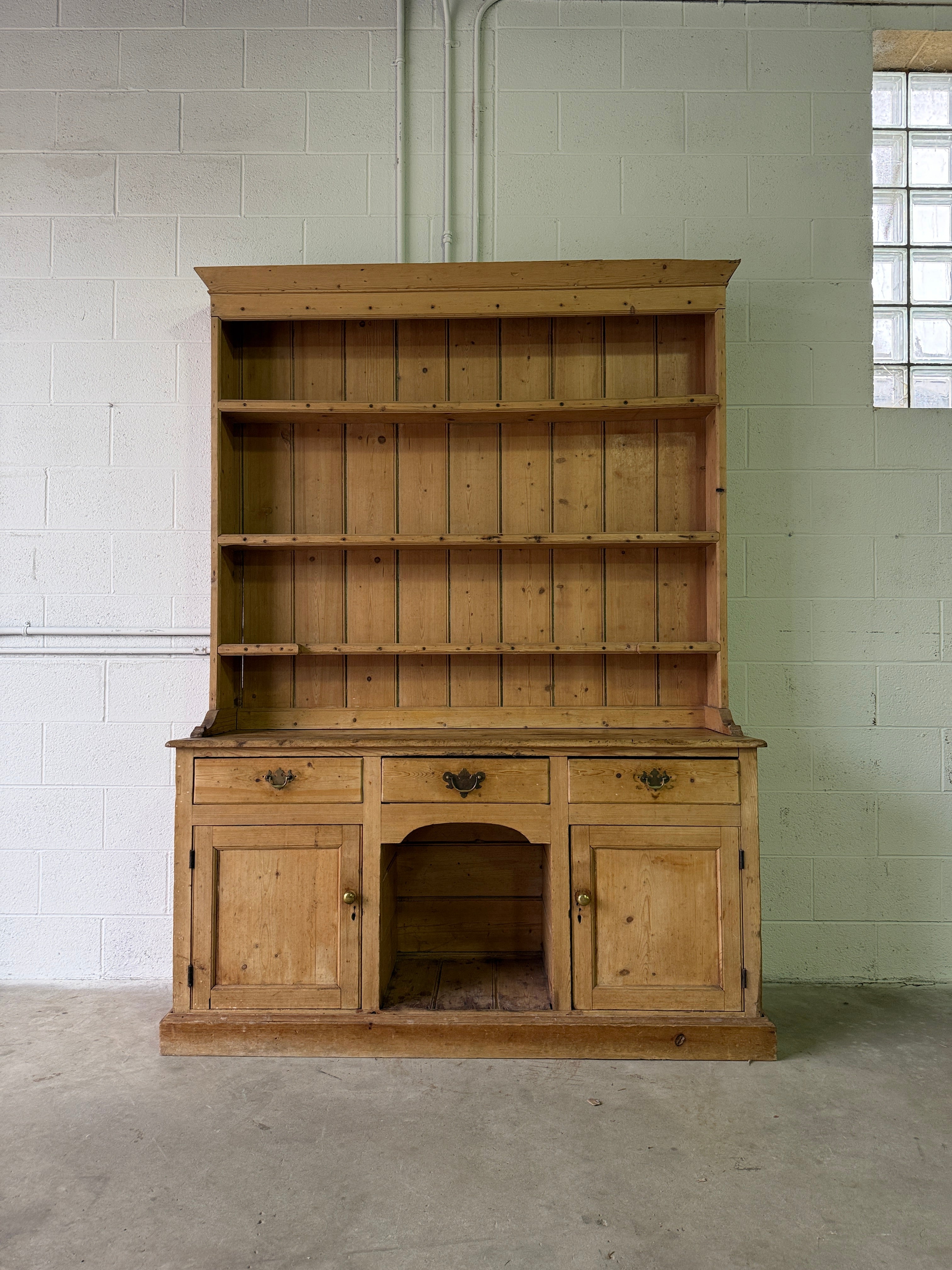 Striking antique pine kitchen dresser with brass pulls