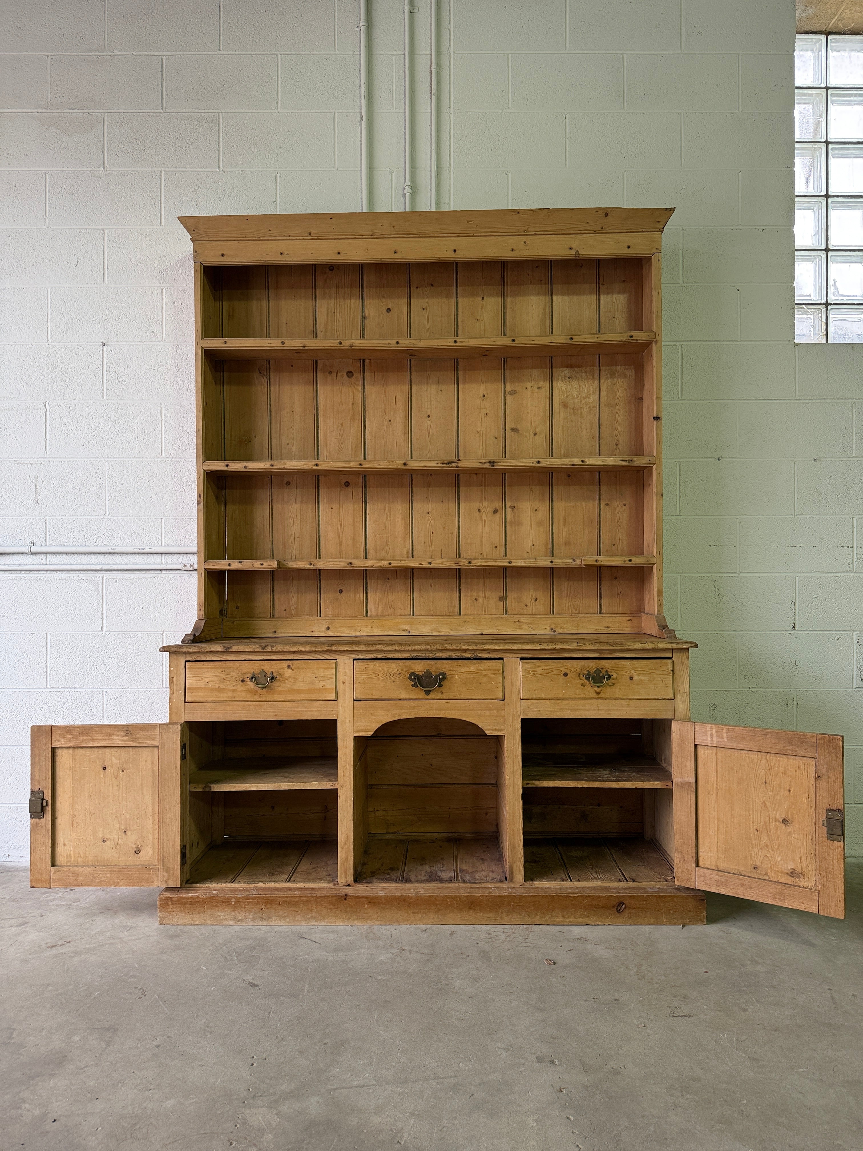 Striking antique pine kitchen dresser with brass pulls