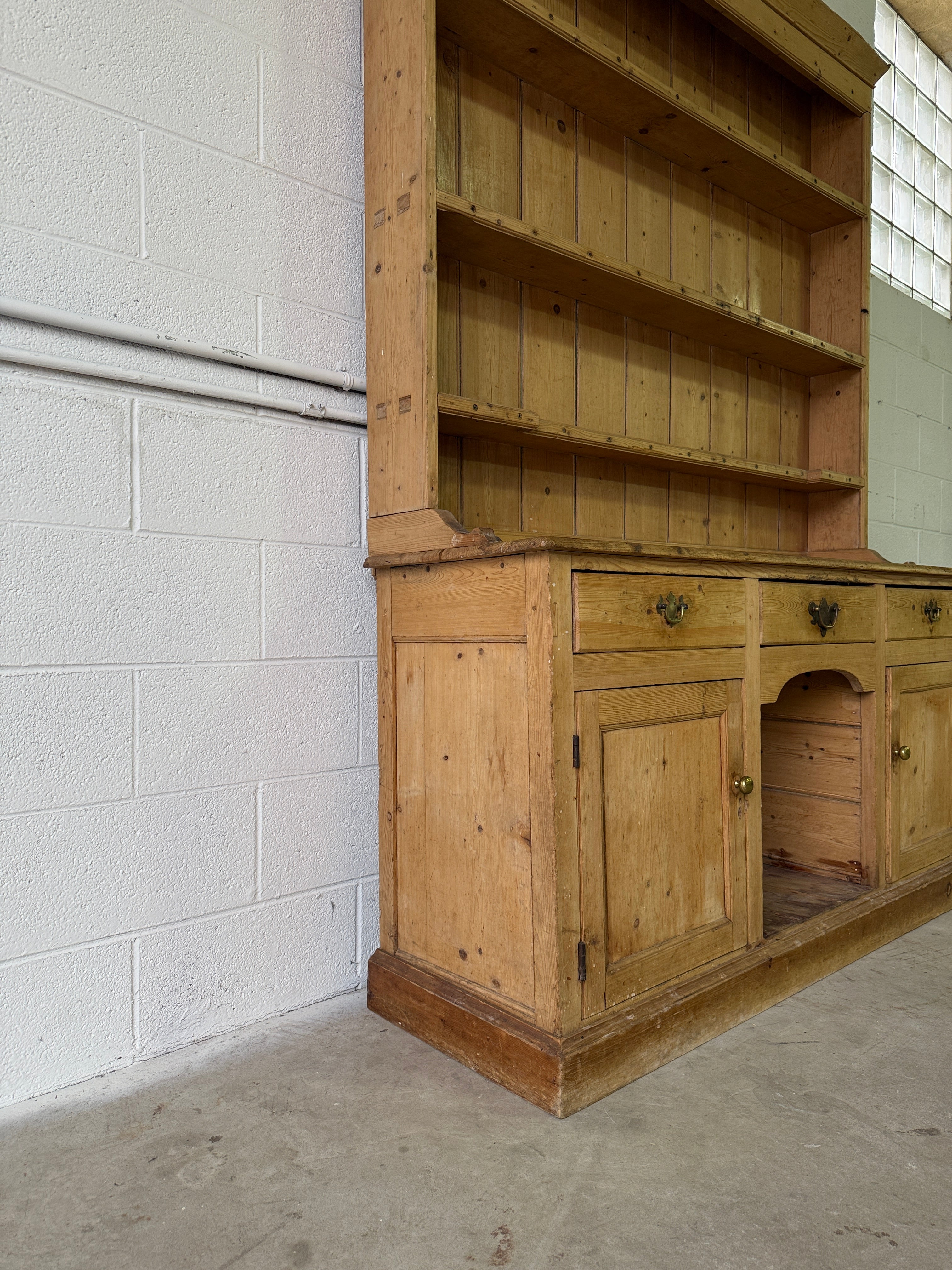 Striking antique pine kitchen dresser with brass pulls