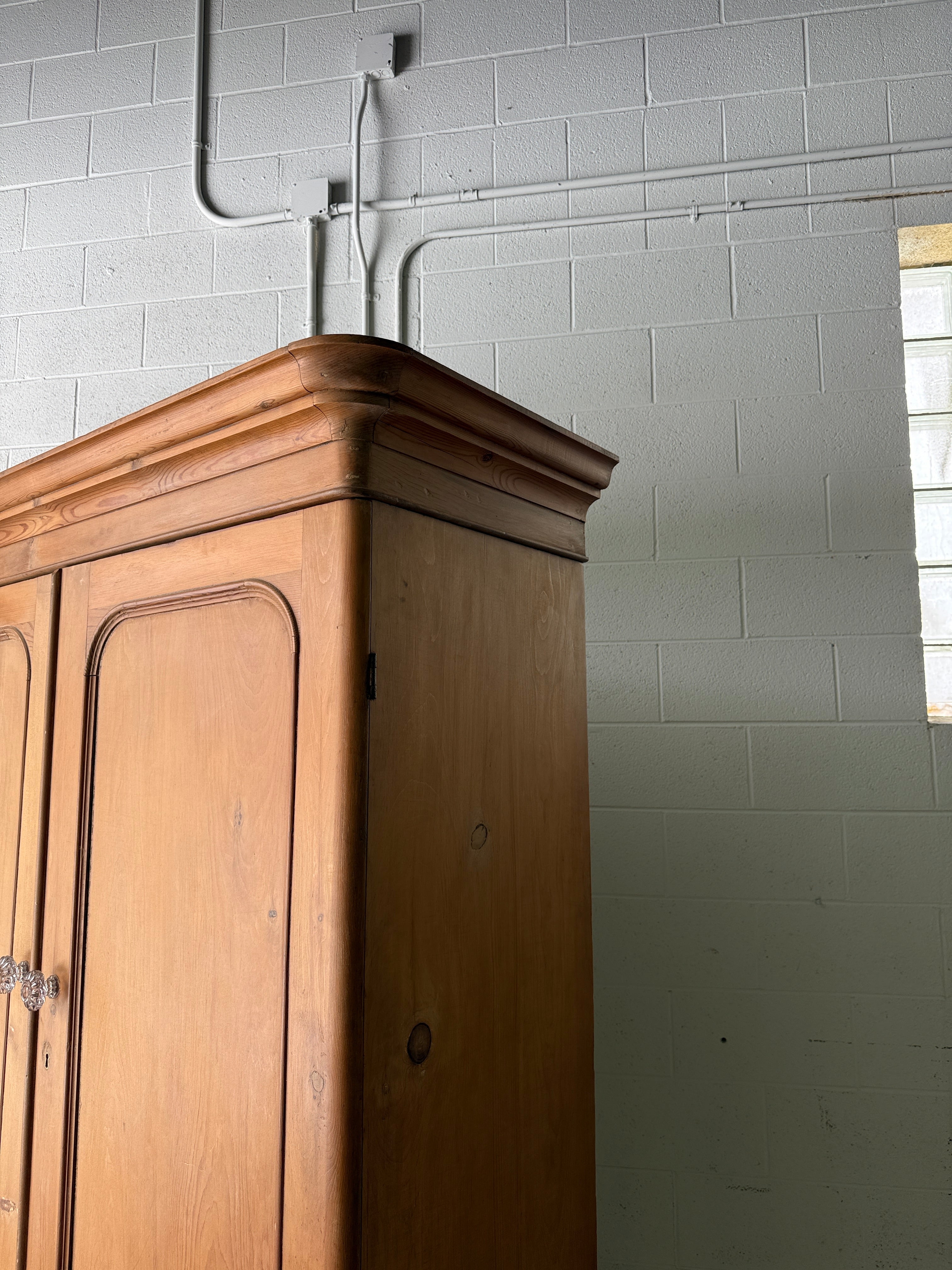 Substantial antique pine double wardrobe with painted interior