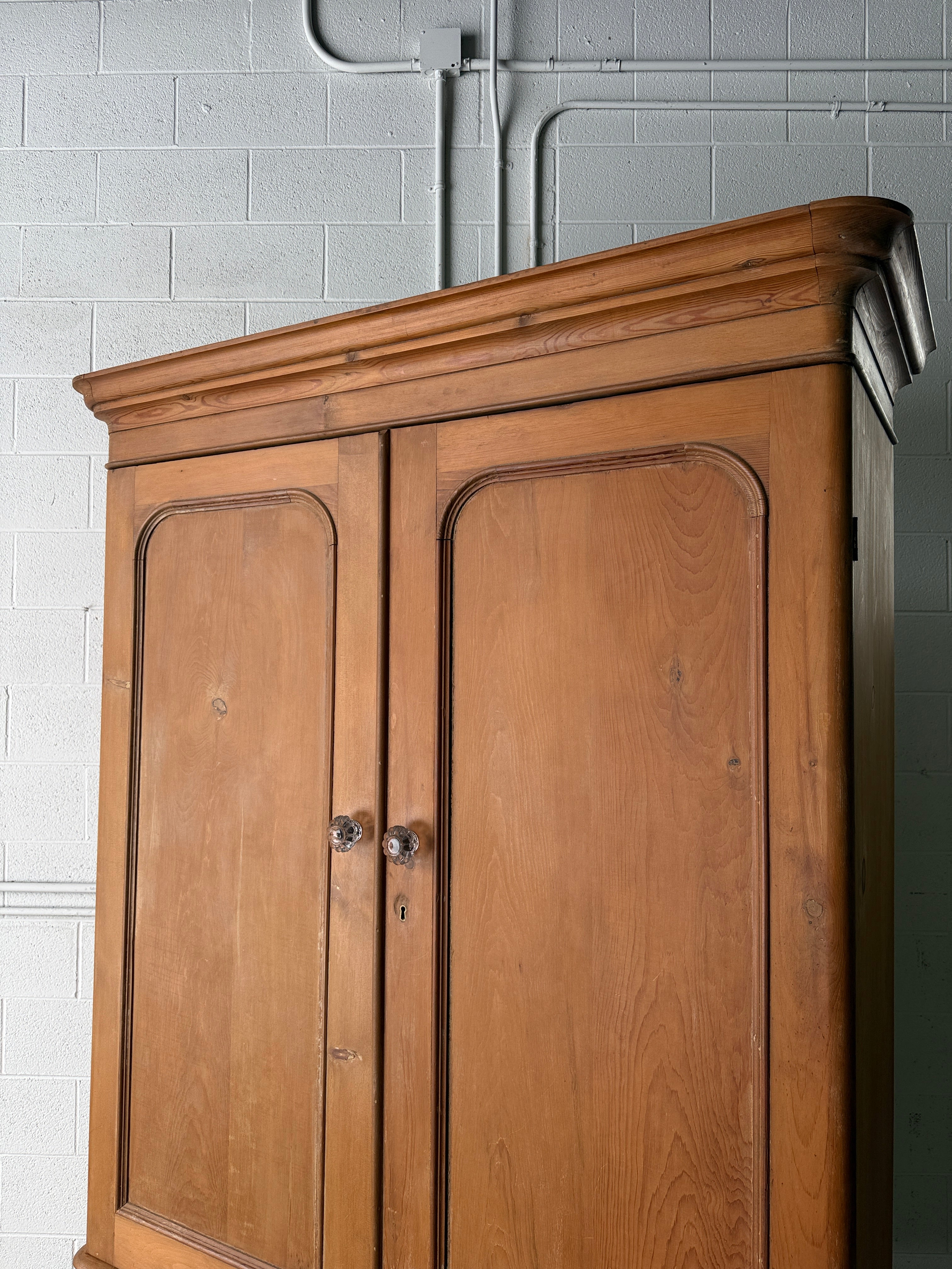 Substantial antique pine double wardrobe with painted interior