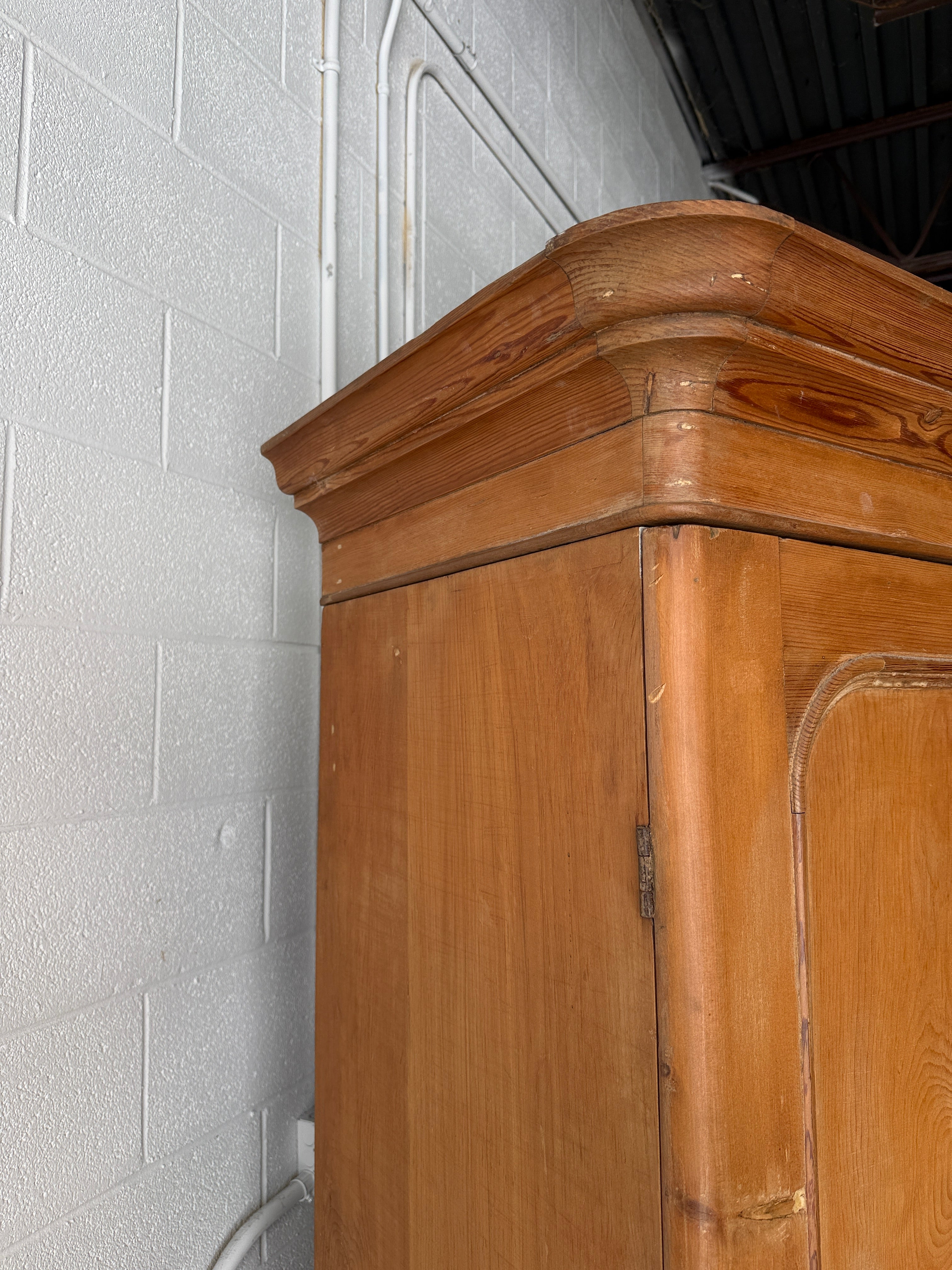 Substantial antique pine double wardrobe with painted interior