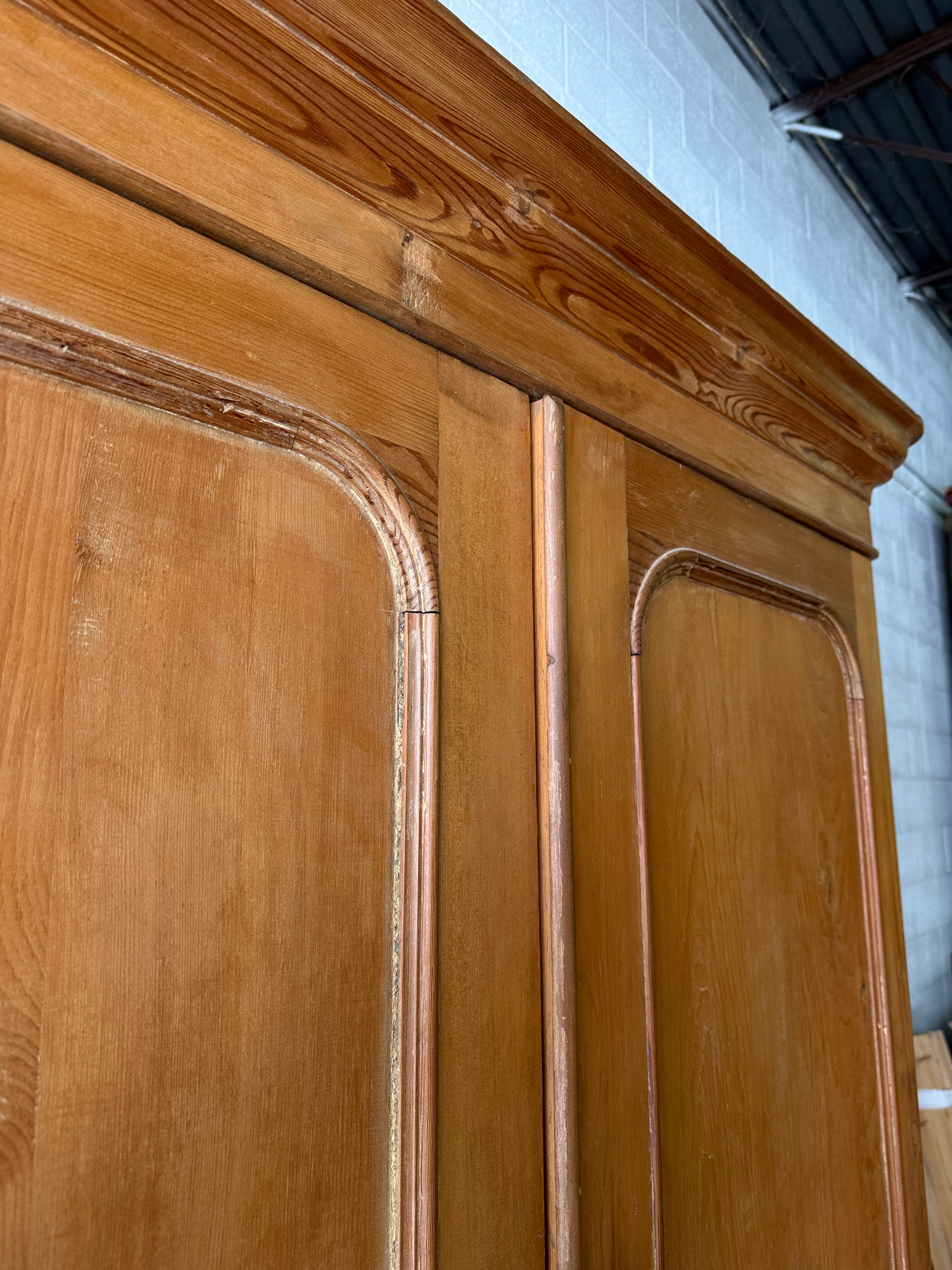 Substantial antique pine double wardrobe with painted interior