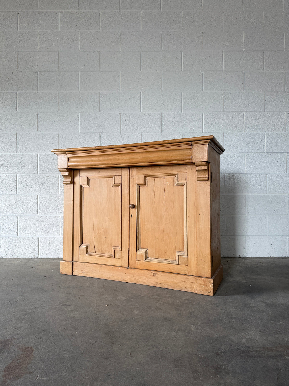 Antique European pine cupboard with hidden upper drawer
