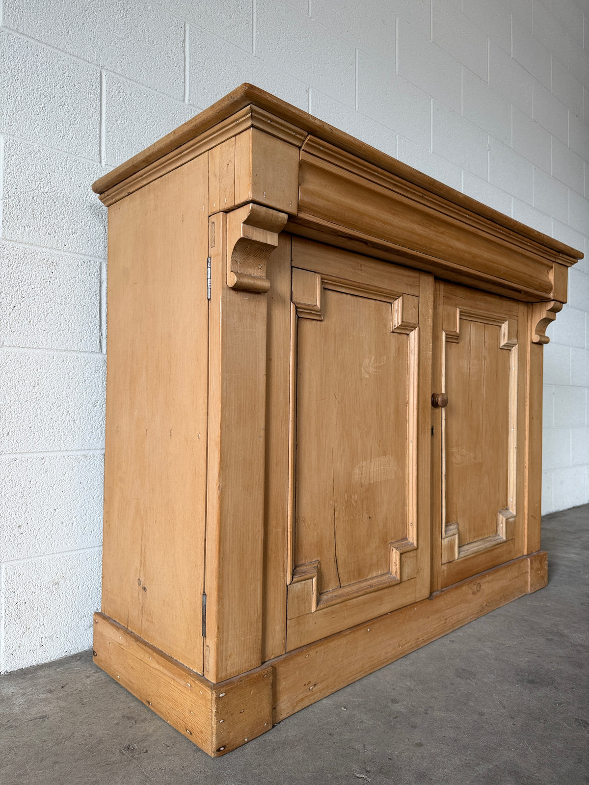 Antique European pine cupboard with hidden upper drawer