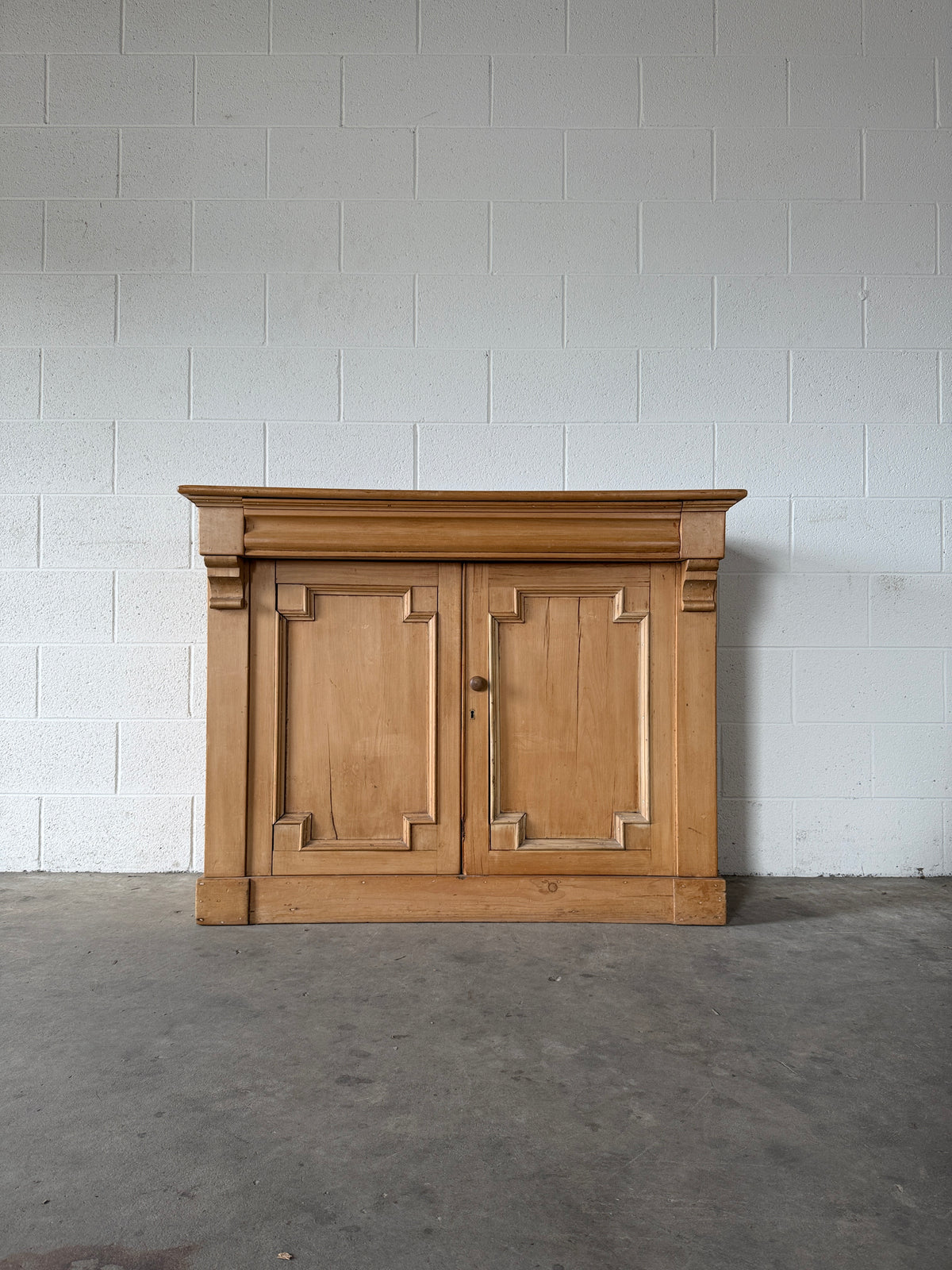 Antique European pine cupboard with hidden upper drawer