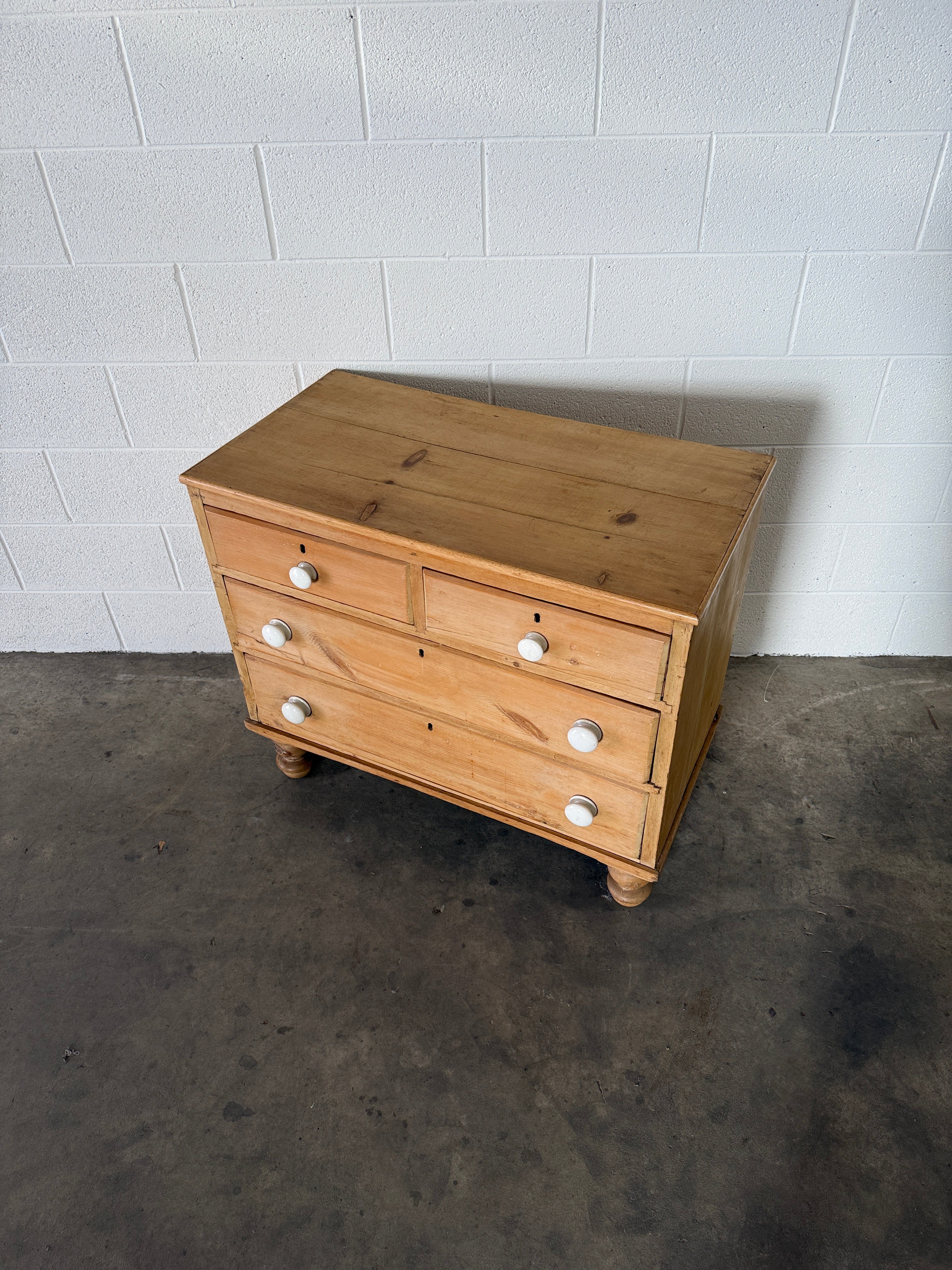 Petite pine chest of drawers with original porcelain knobs