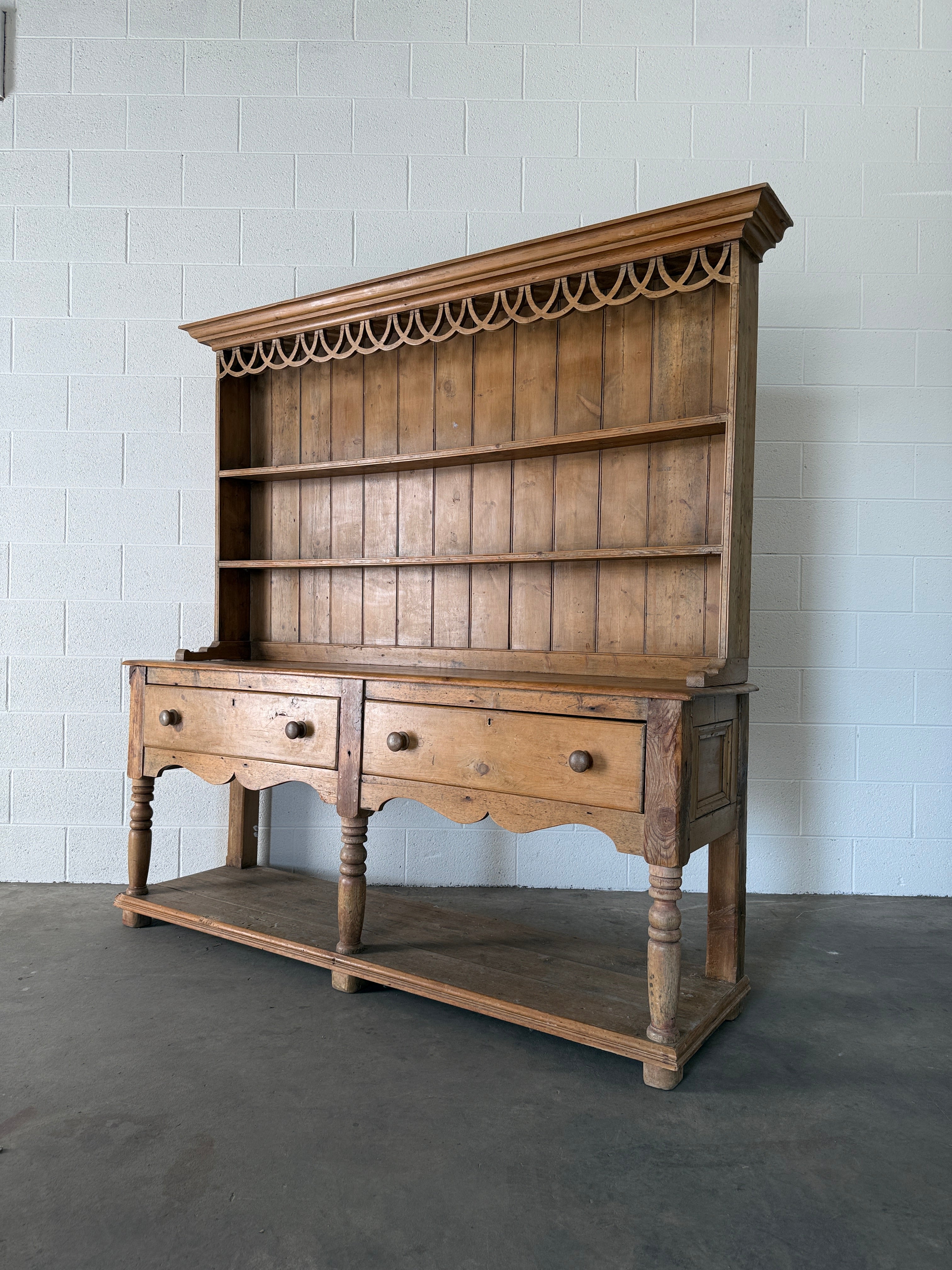 Antique pine kitchen dresser with decorative top