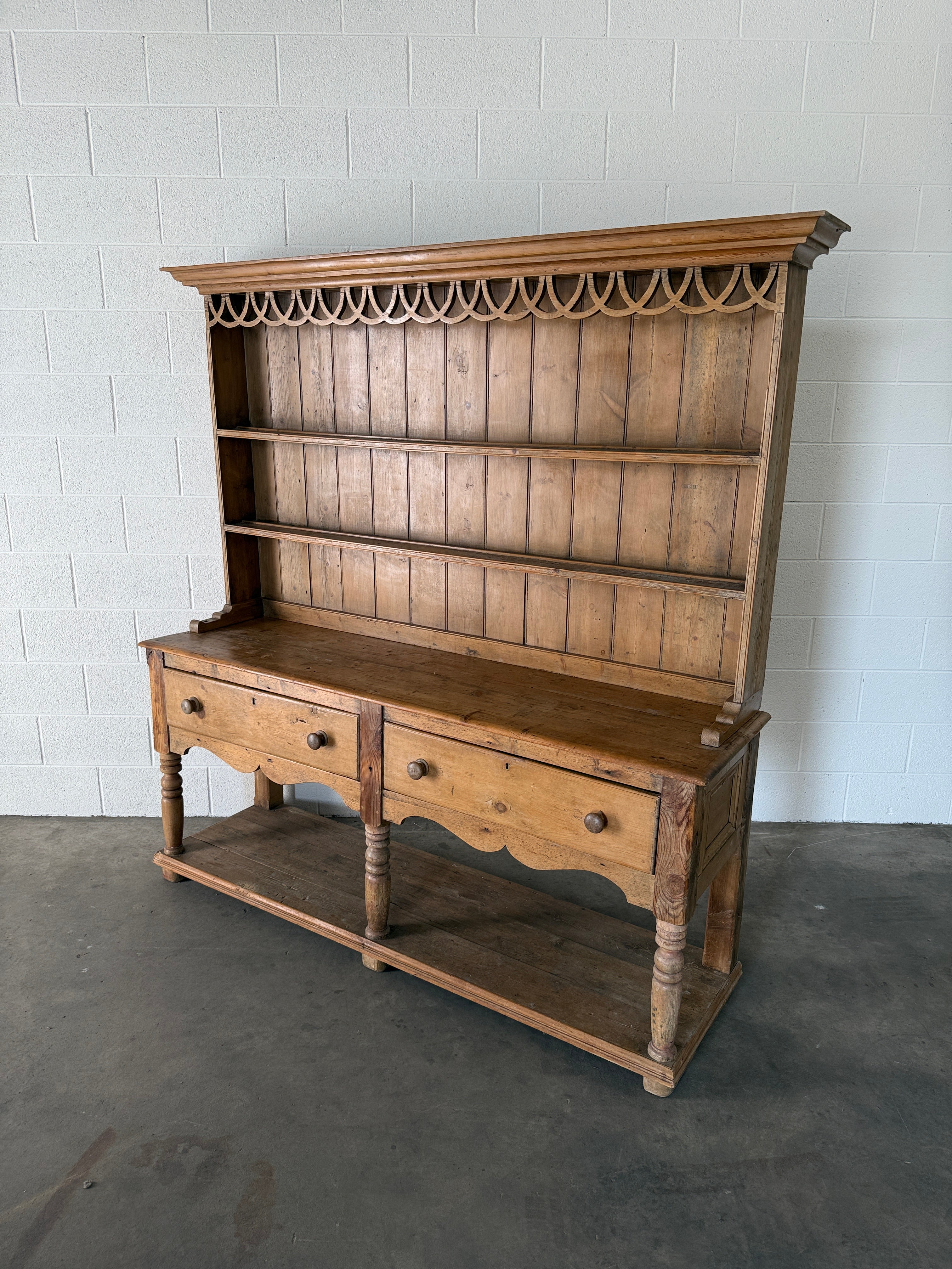 Antique pine kitchen dresser with decorative top