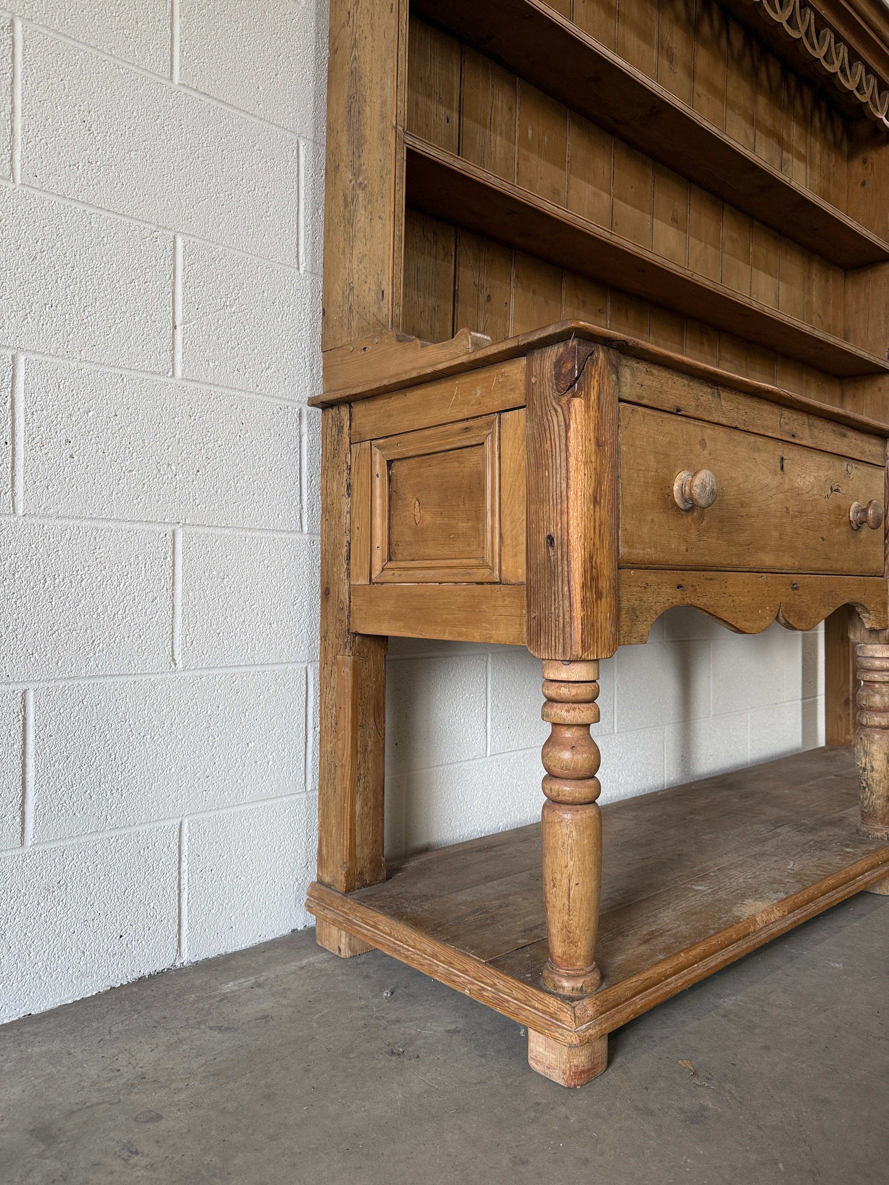 Antique pine kitchen dresser with decorative top