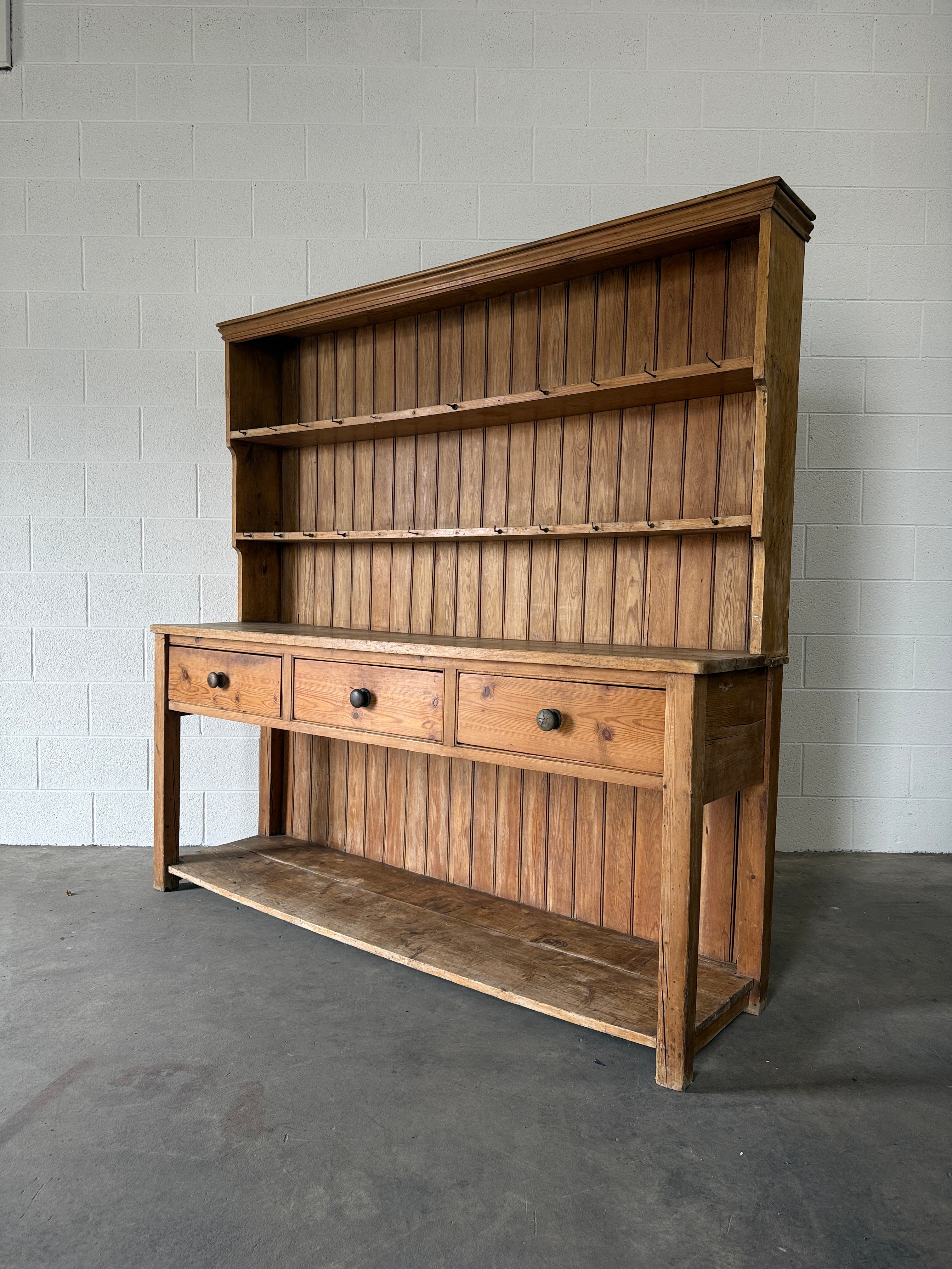 Simple antique English pine kitchen dresser with potboard base