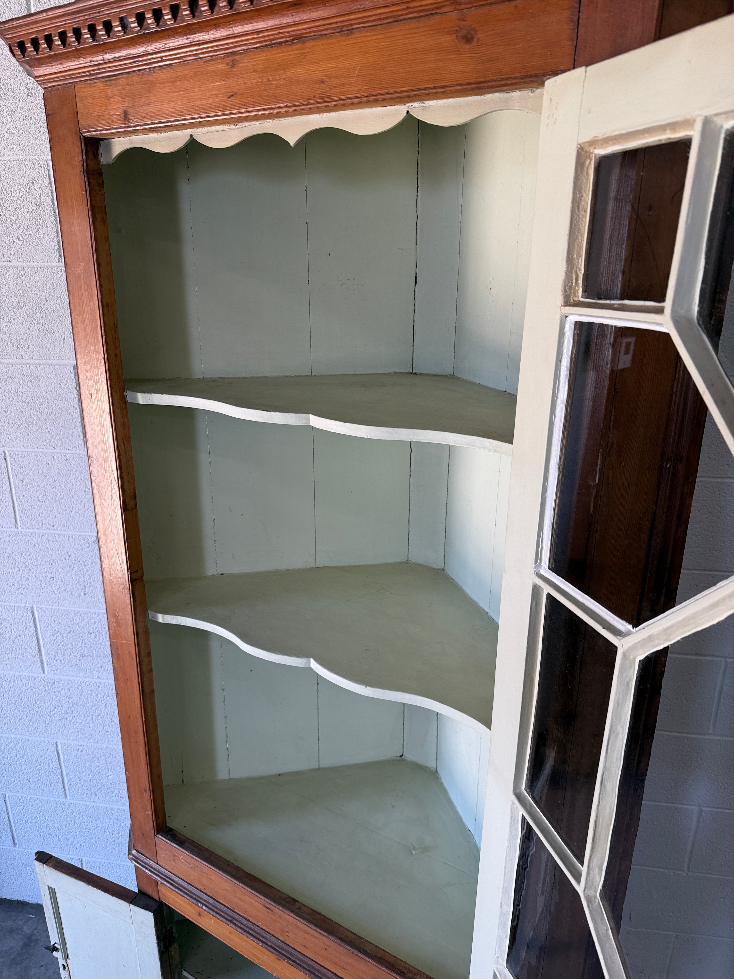 Antique English pine corner cabinet with glazed astragal door