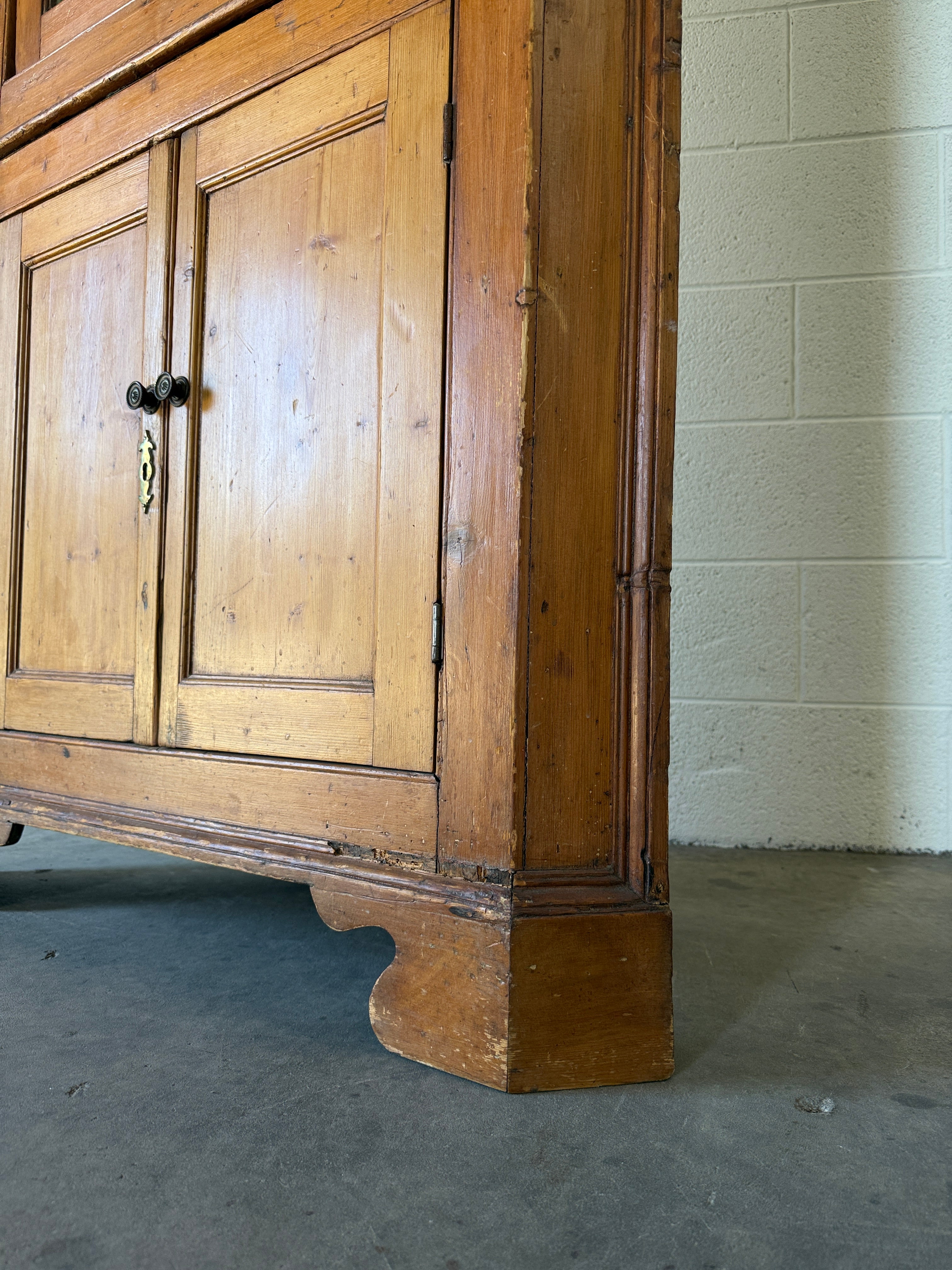 Antique English pine corner cabinet with glazed astragal door