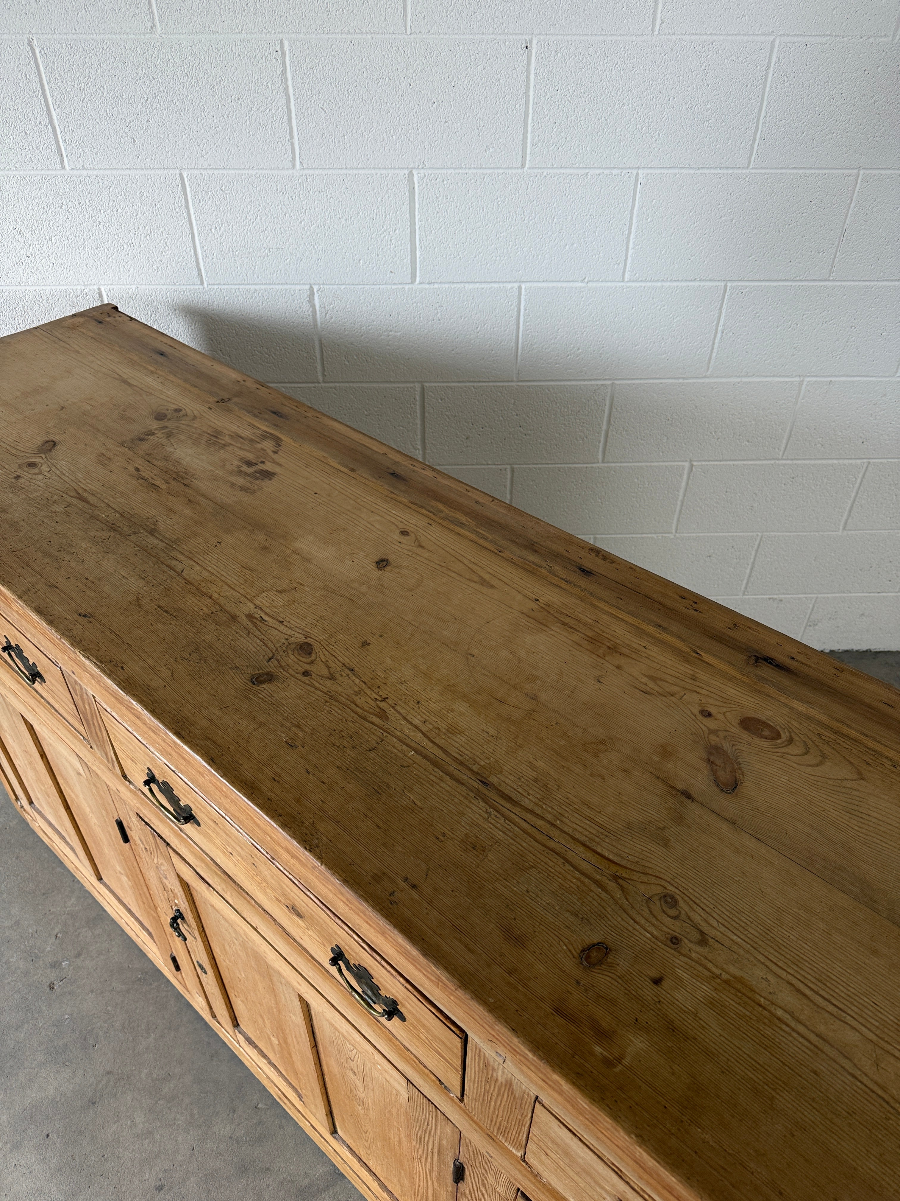 19th‑century English pine sideboard with three drawers and cupboards below
