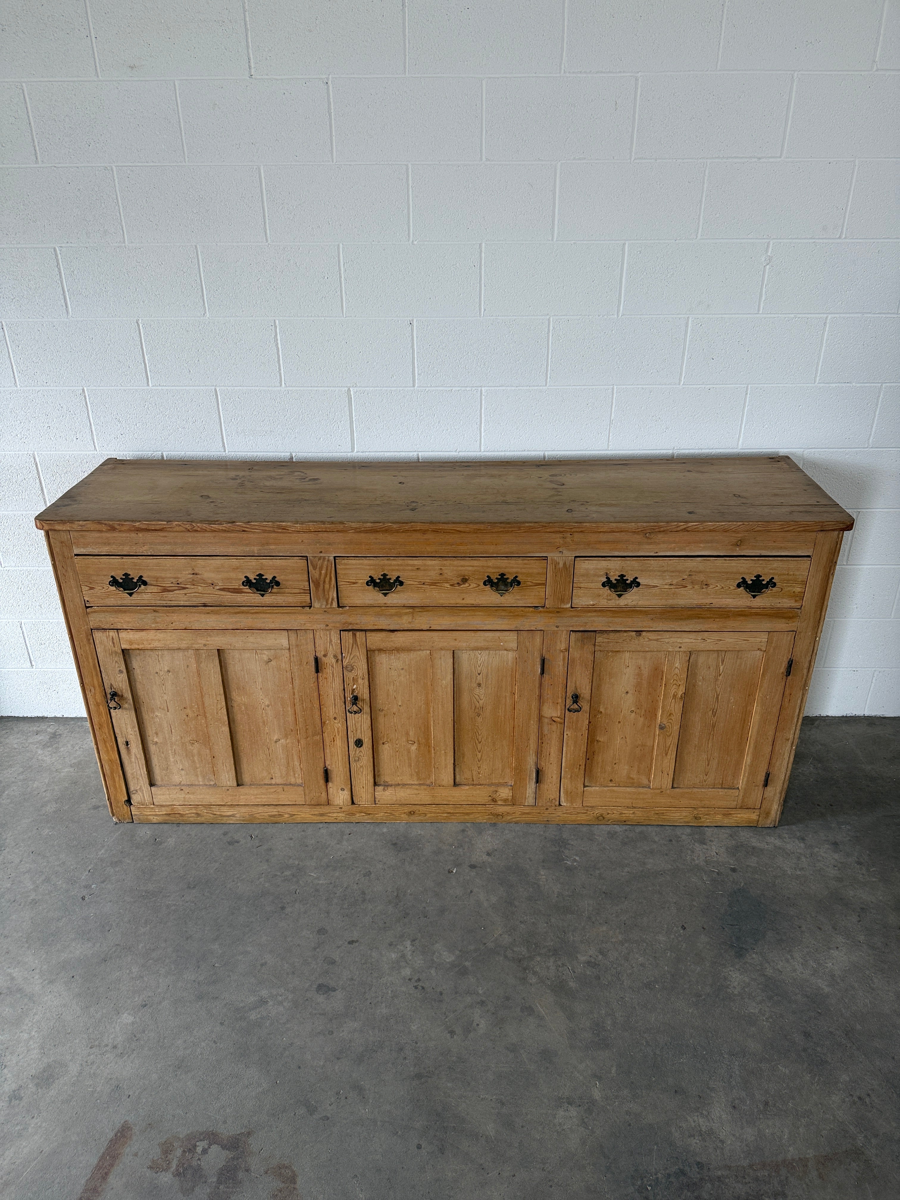 19th‑century English pine sideboard with three drawers and cupboards below