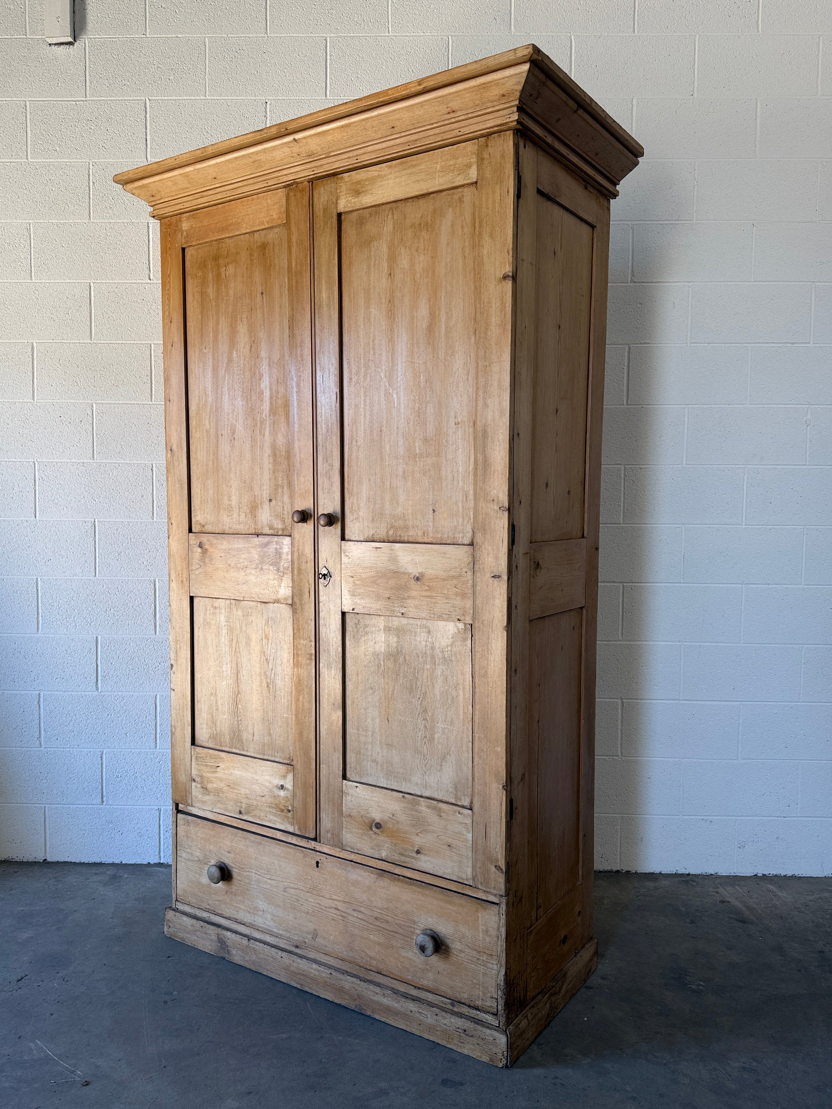 Early–mid 19th‑century English pine wardrobe with base drawer