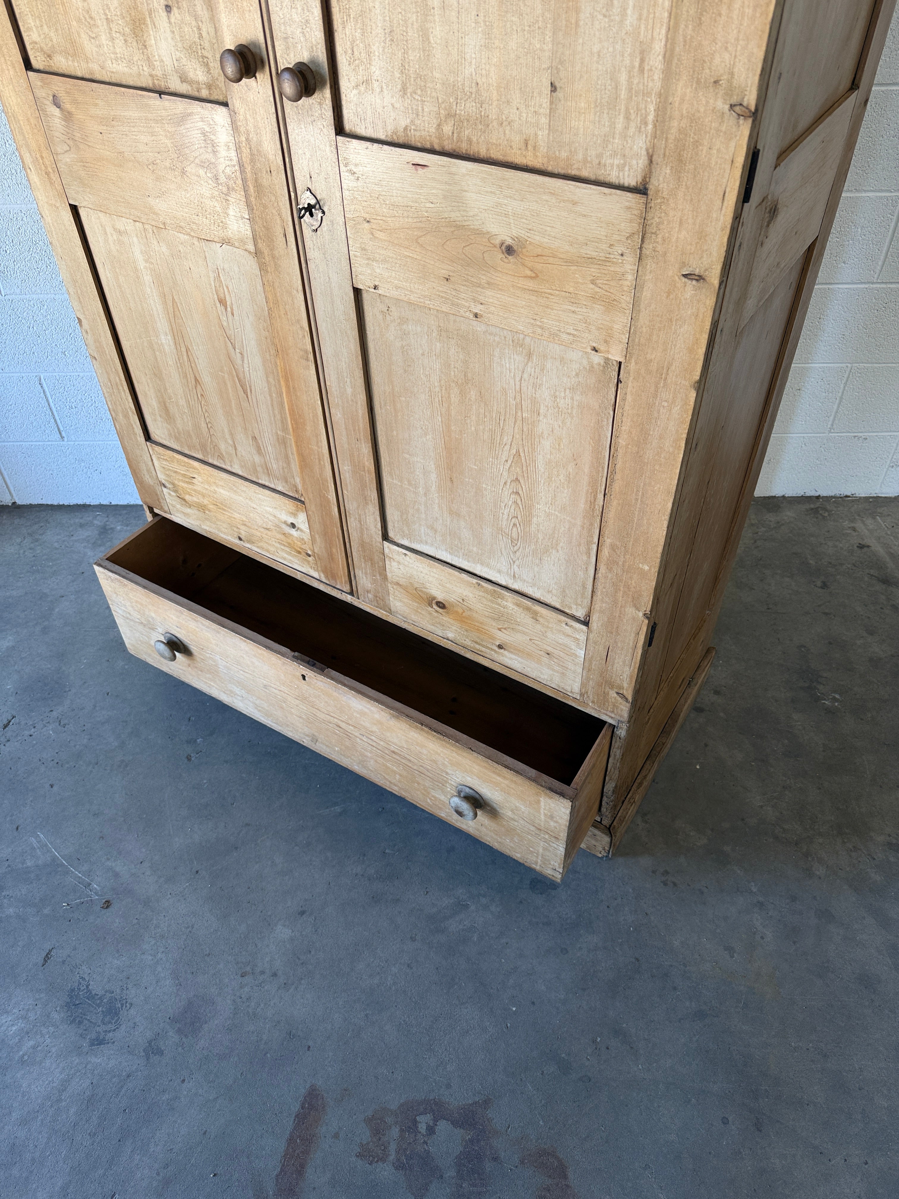 Early–mid 19th‑century English pine wardrobe with base drawer