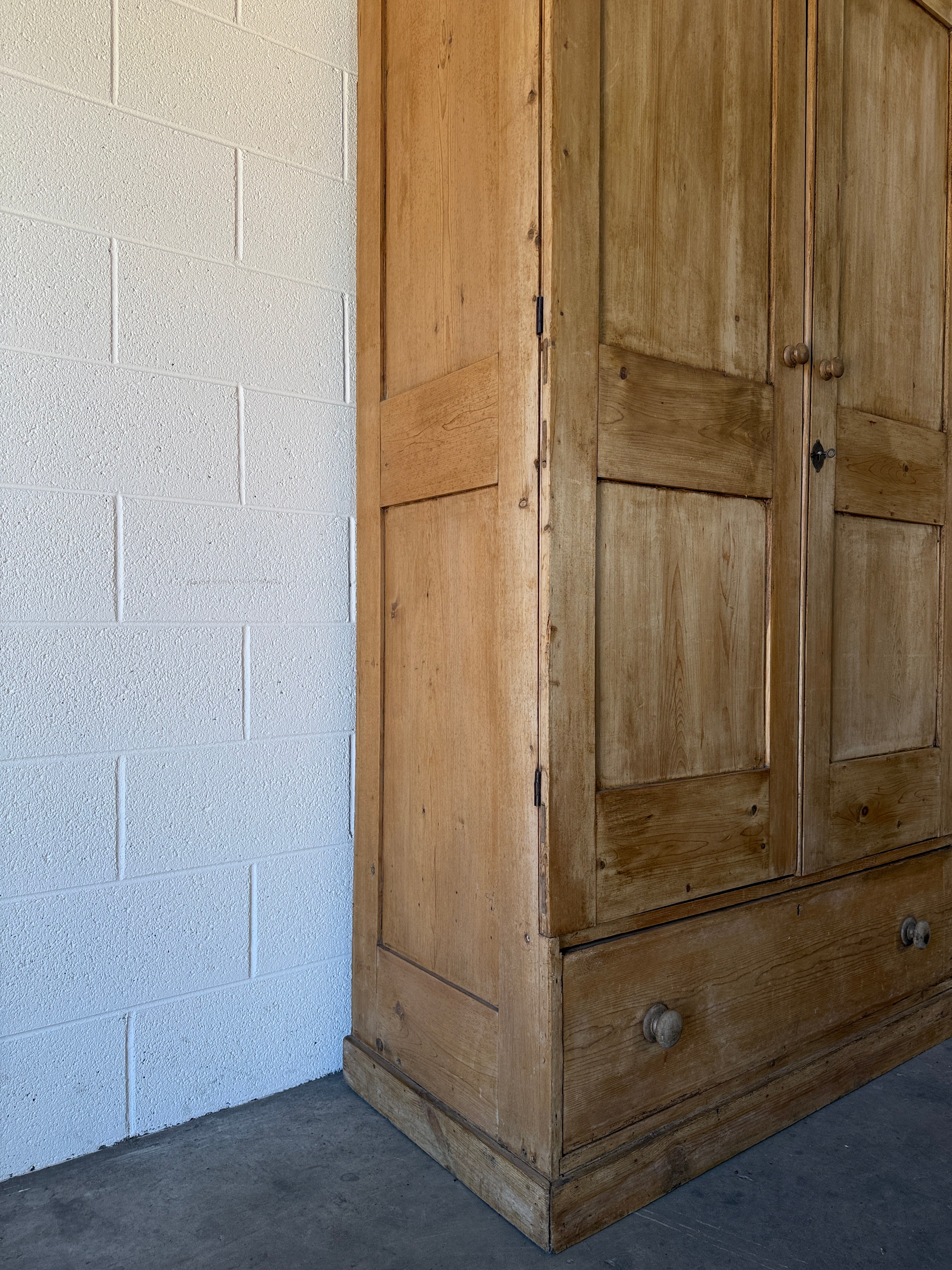 Early–mid 19th‑century English pine wardrobe with base drawer