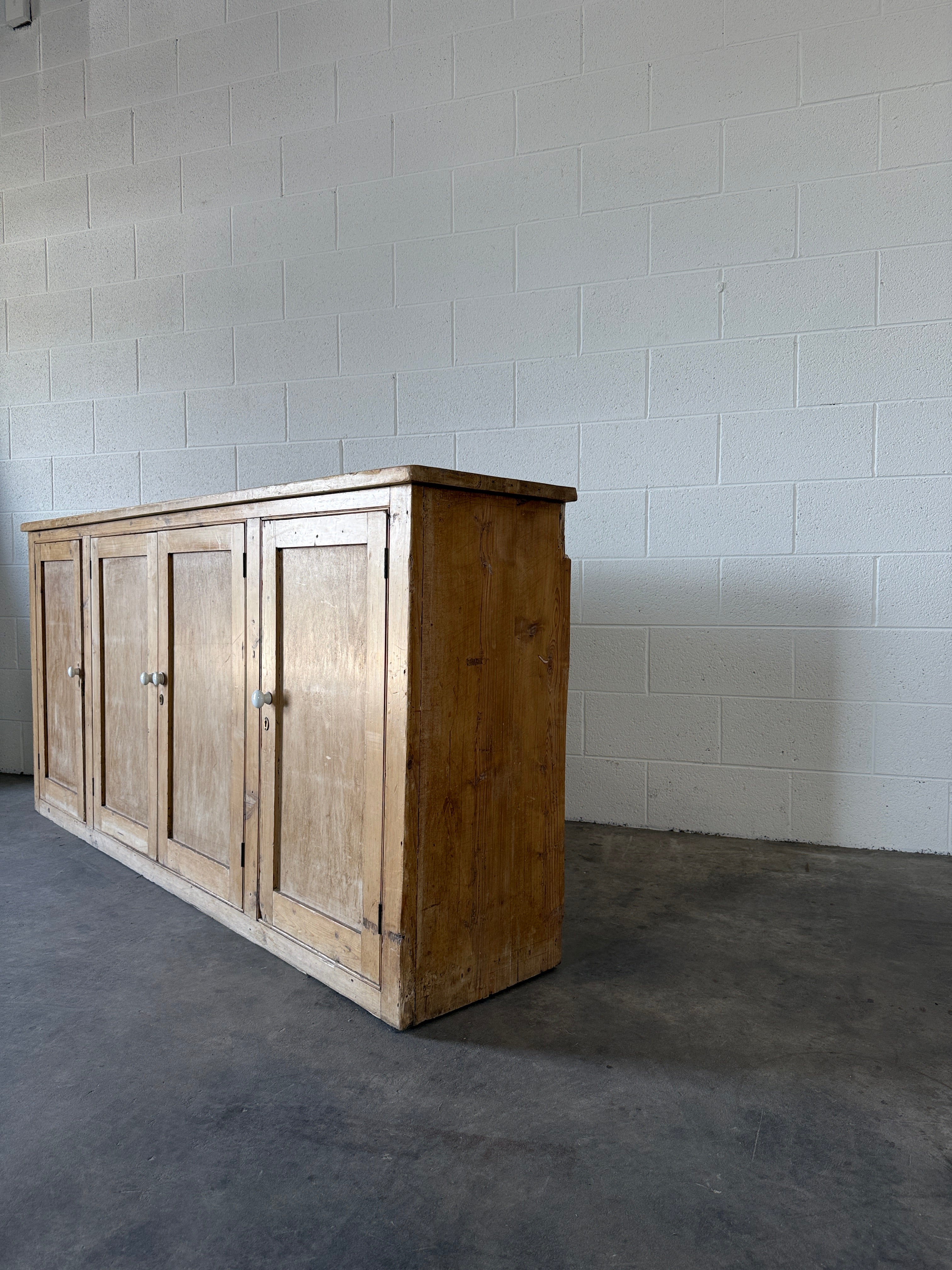 Simple antique pine sideboard with four doors