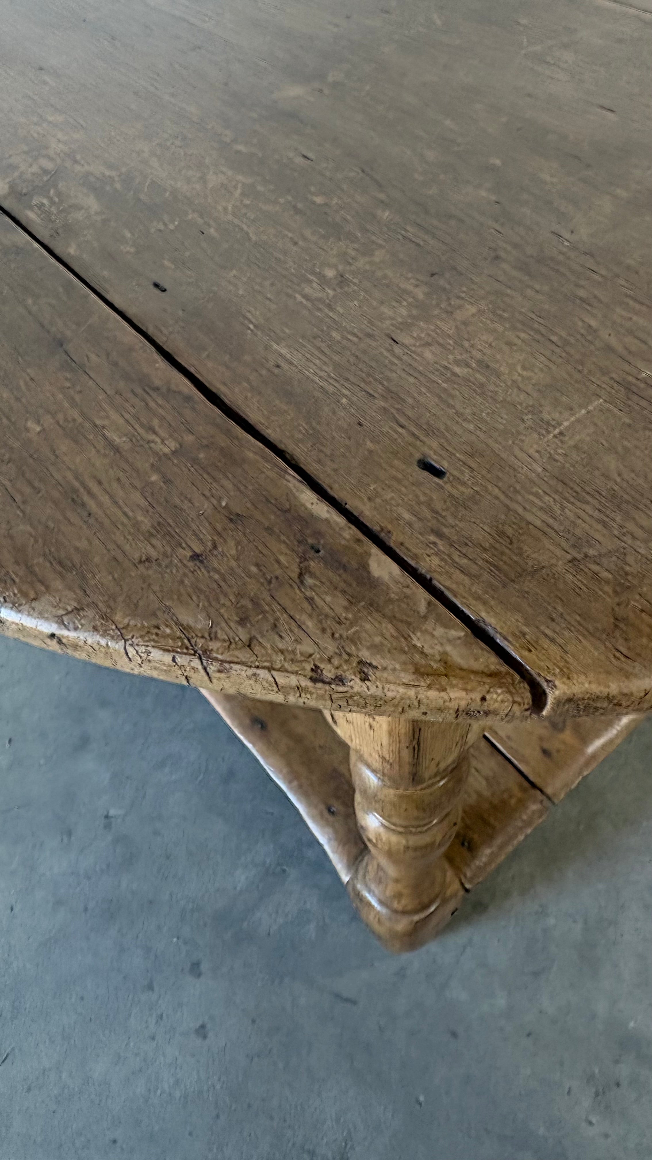 Small round pine coffee table with lower shelf