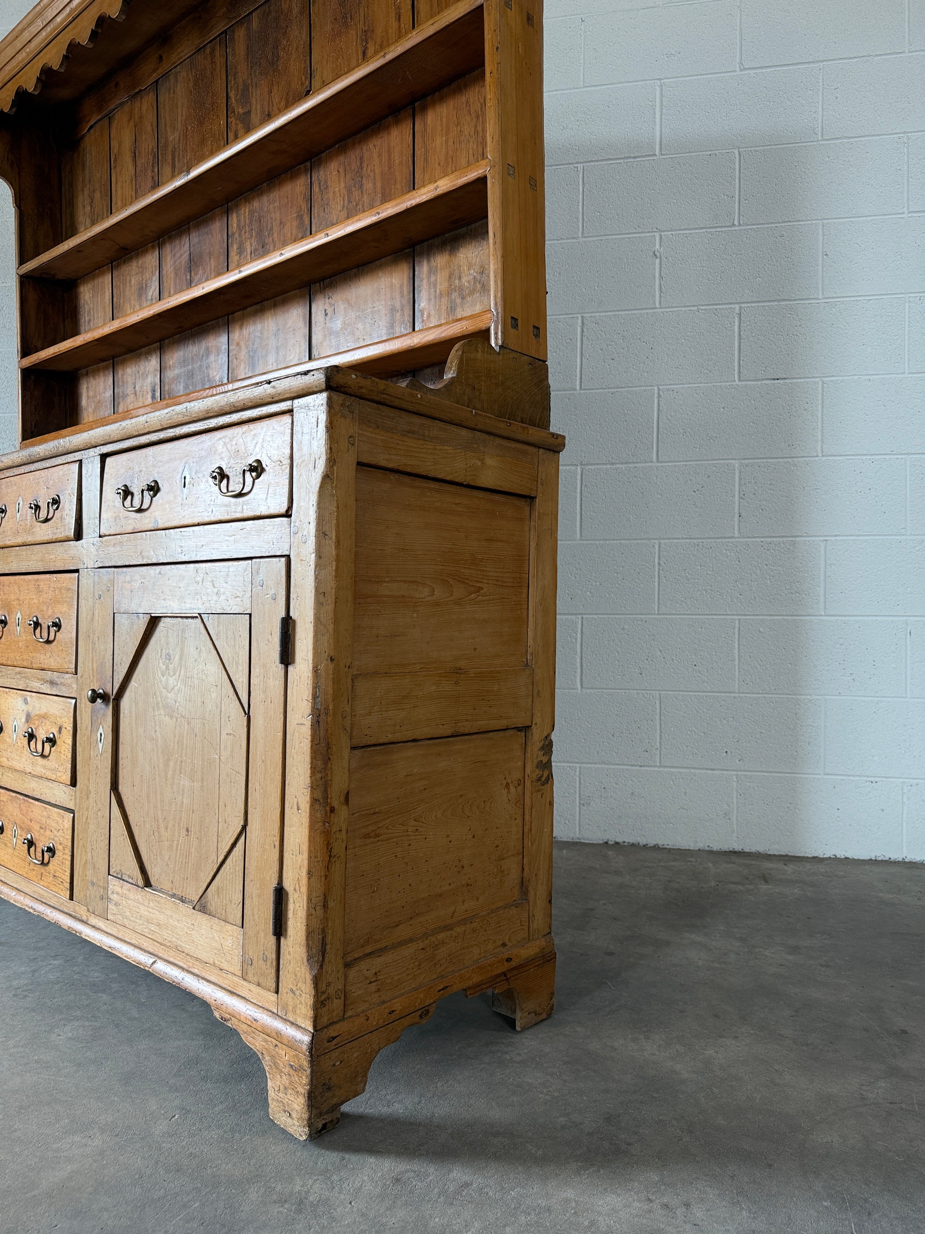 Antique English pine kitchen dresser with paneled doors and detailed trim work