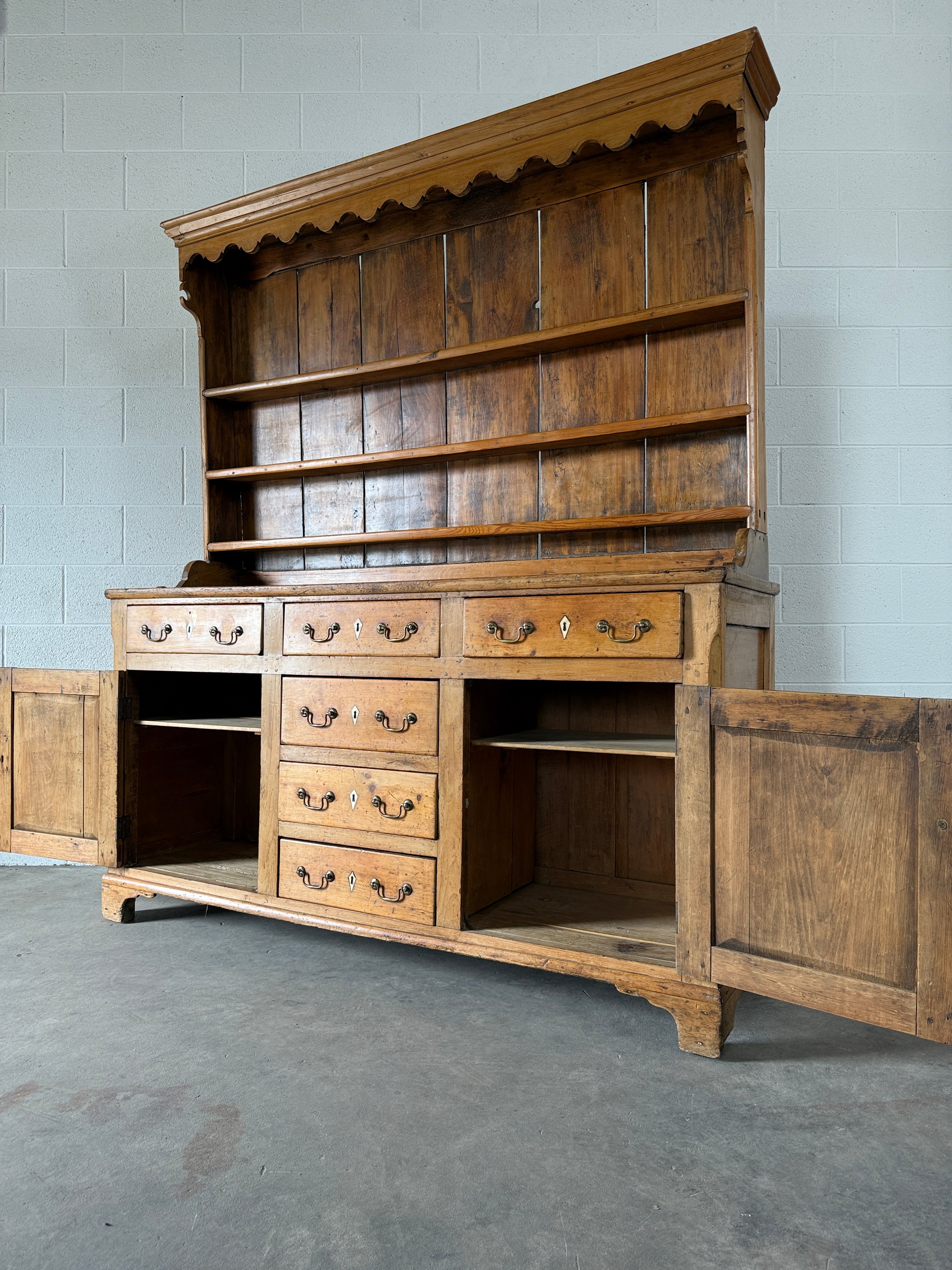 Antique English pine kitchen dresser with paneled doors and detailed trim work