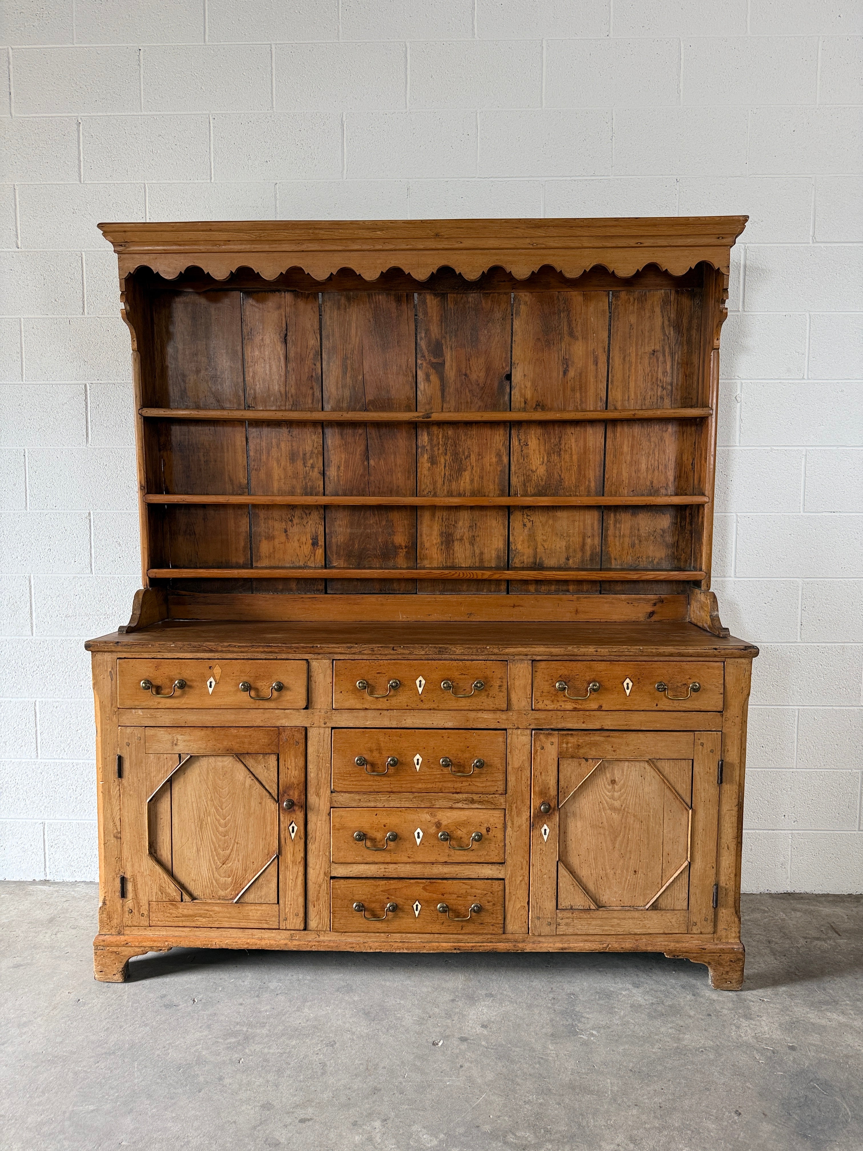 Antique English pine kitchen dresser with paneled doors and detailed trim work
